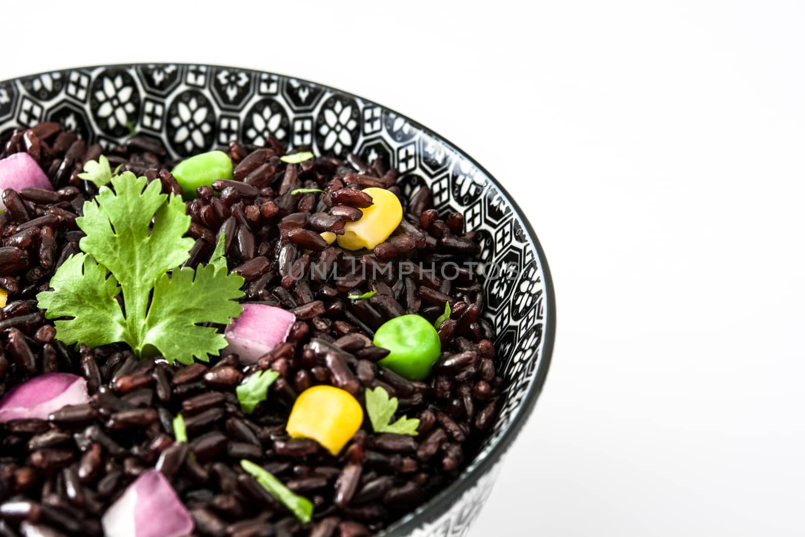 Black rice and vegetables isolated on white background