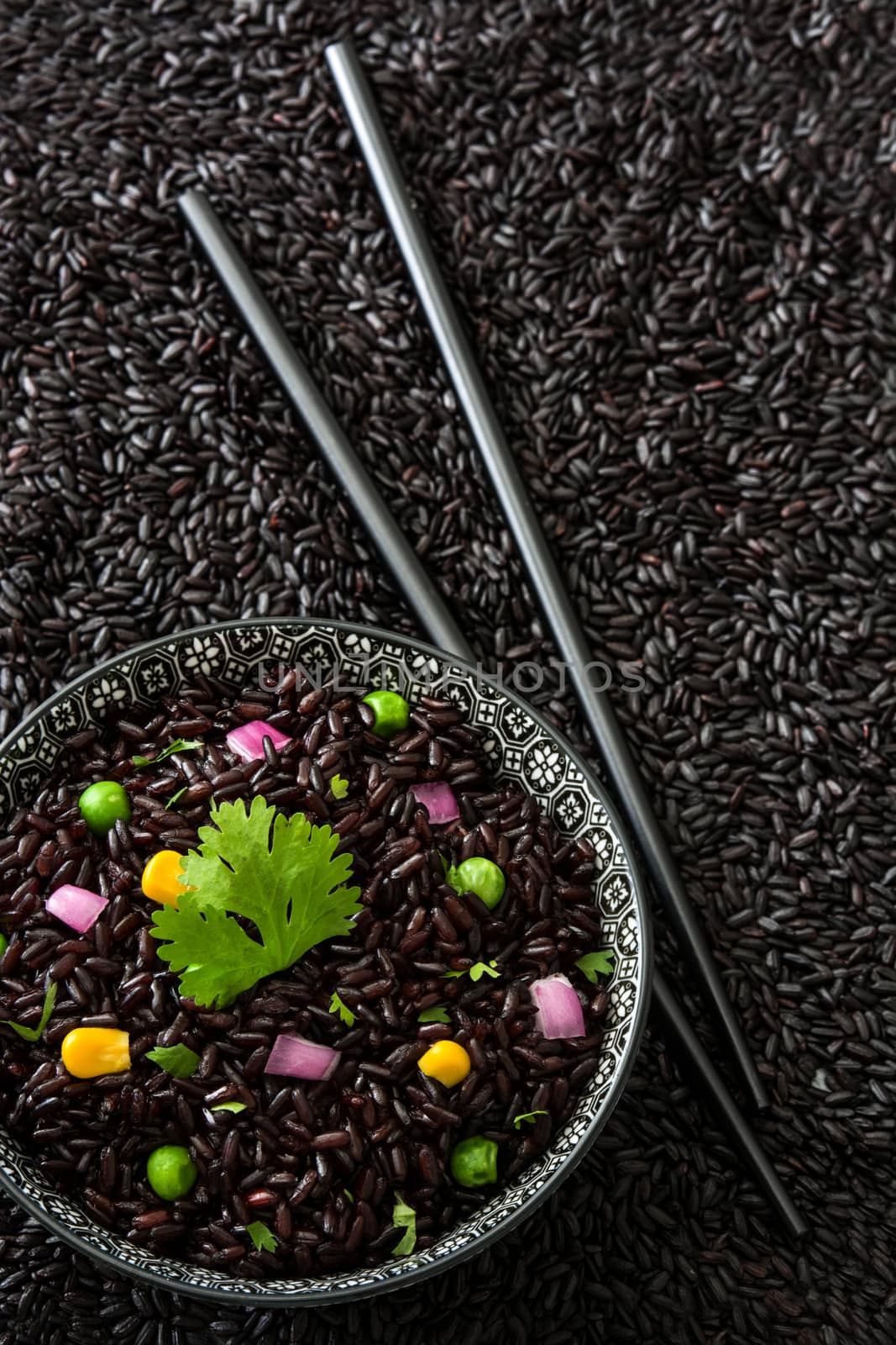 Black rice in a bowl and vegetables