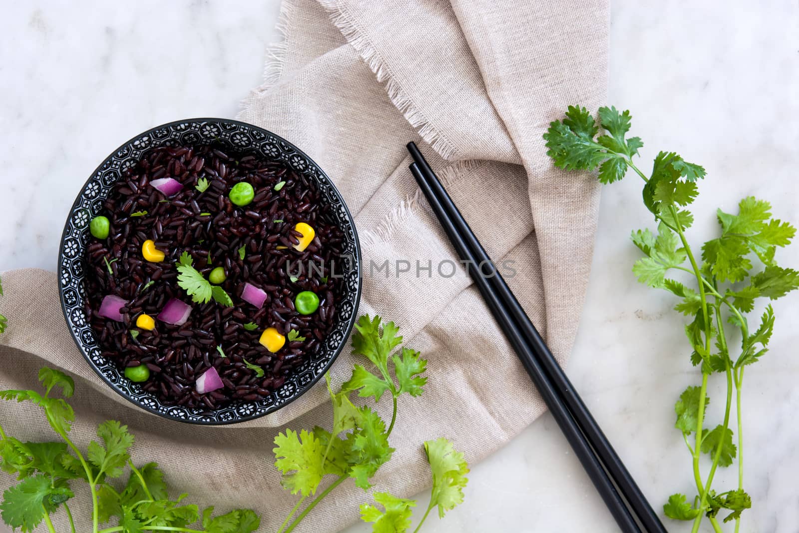 Black rice in a bowl and vegetables by chandlervid85