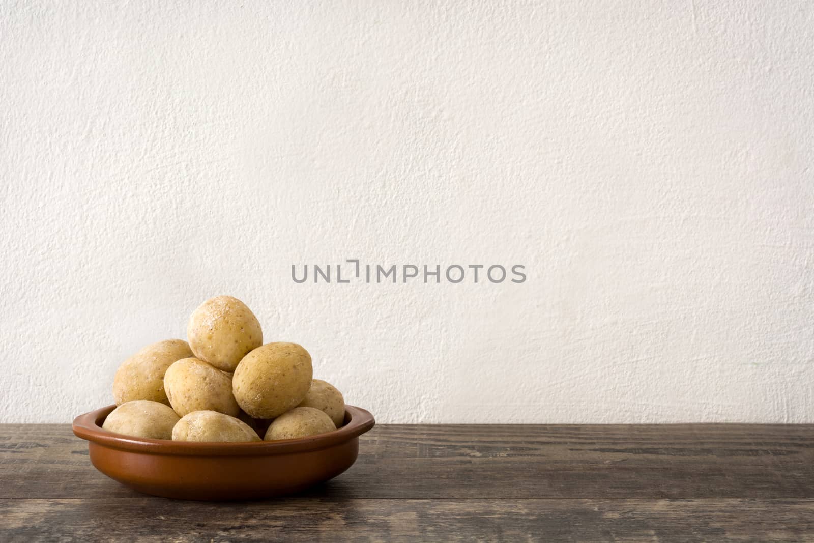 Canarian potatoes (papas arrugadas) on wooden table