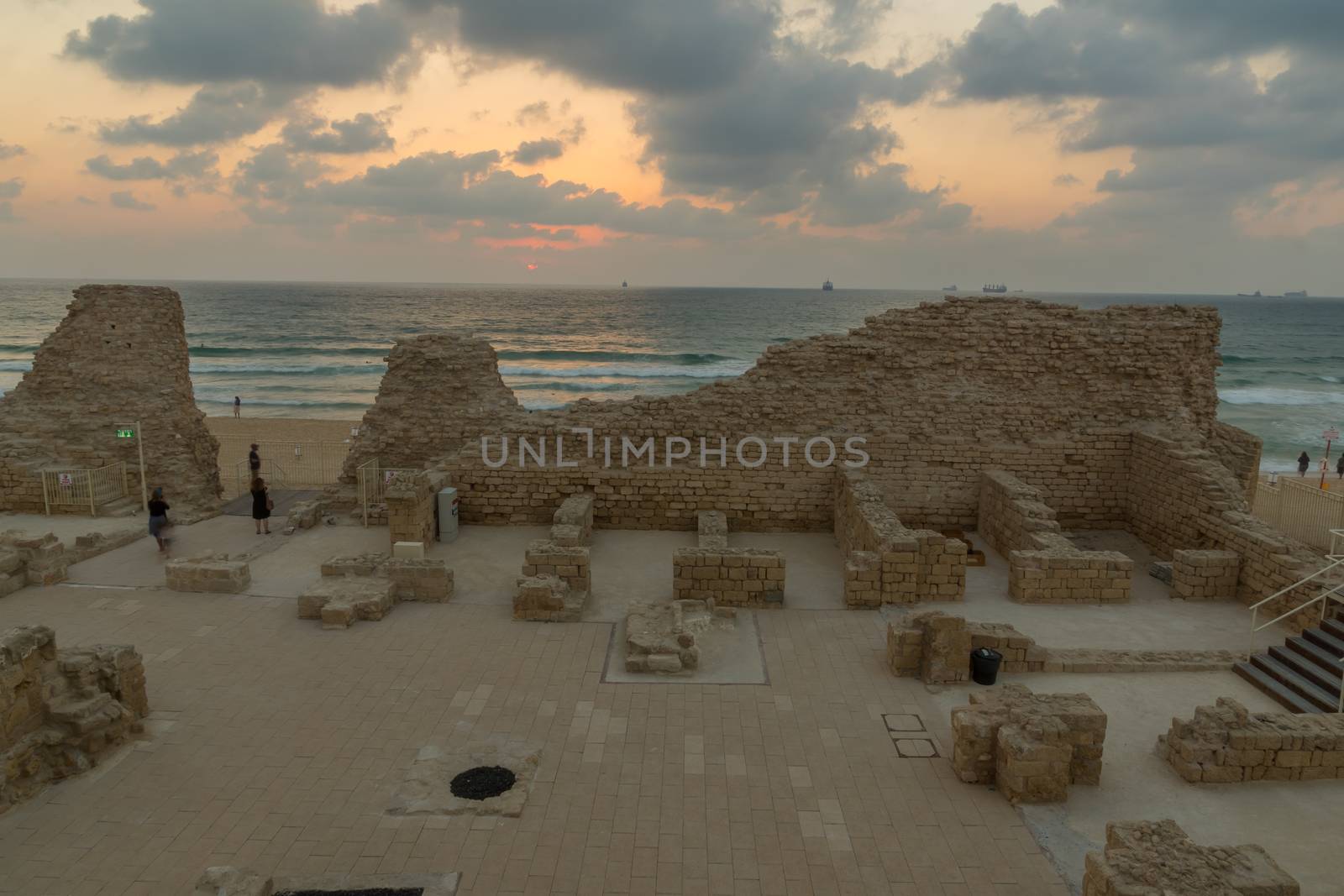 Ashdod, Israel - August 12, 2020: Sunset view of the remains of Ashdod Citadel (Ashdod Yam or Ashdod on the Sea), with visitors. Southern Israel
