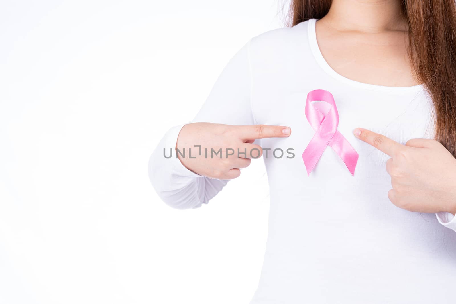 Breast cancer awareness ribbon on woman chest isolated over white background. Medical, healthcare for advertising concept.