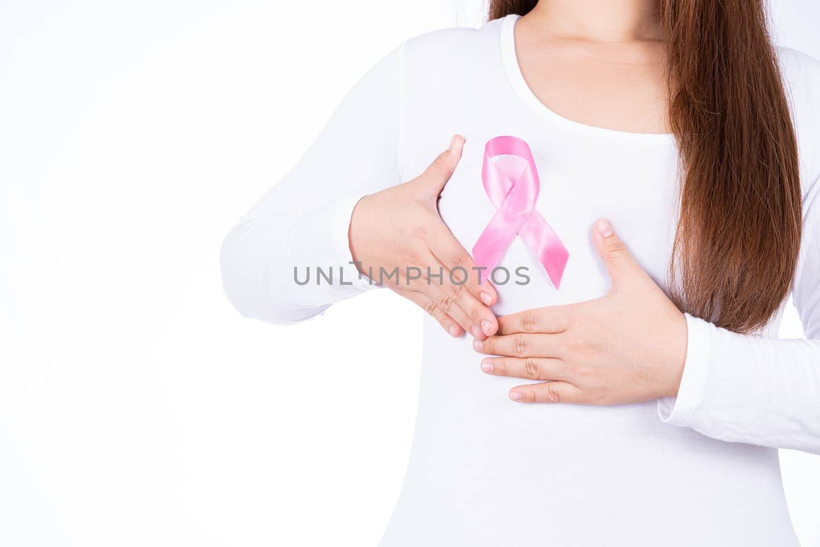 Breast cancer awareness ribbon on woman chest and doing self exam isolated over white background. Medical, healthcare for advertising concept.