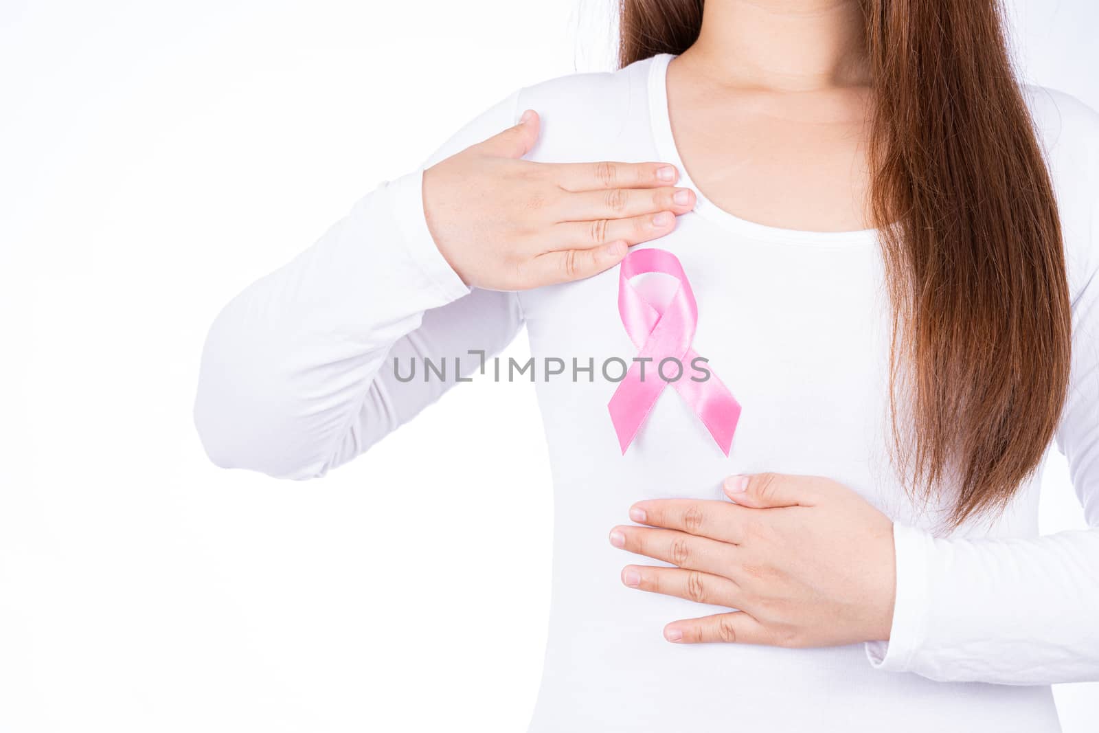 Breast cancer awareness ribbon on woman chest and doing self exam isolated over white background. Medical, healthcare for advertising concept.