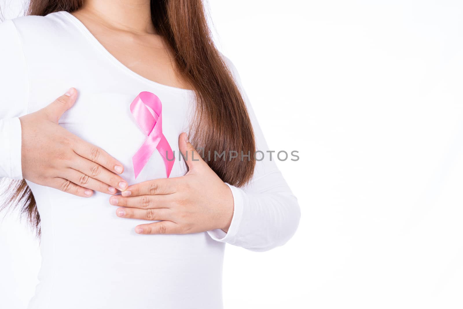 Breast cancer awareness ribbon on woman chest and doing self exam isolated over white background. Medical, healthcare for advertising concept.