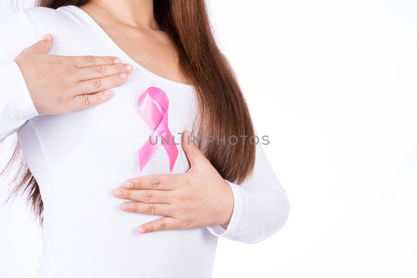 Breast cancer awareness ribbon on woman chest and doing self exam isolated over white background. Medical, healthcare for advertising concept.