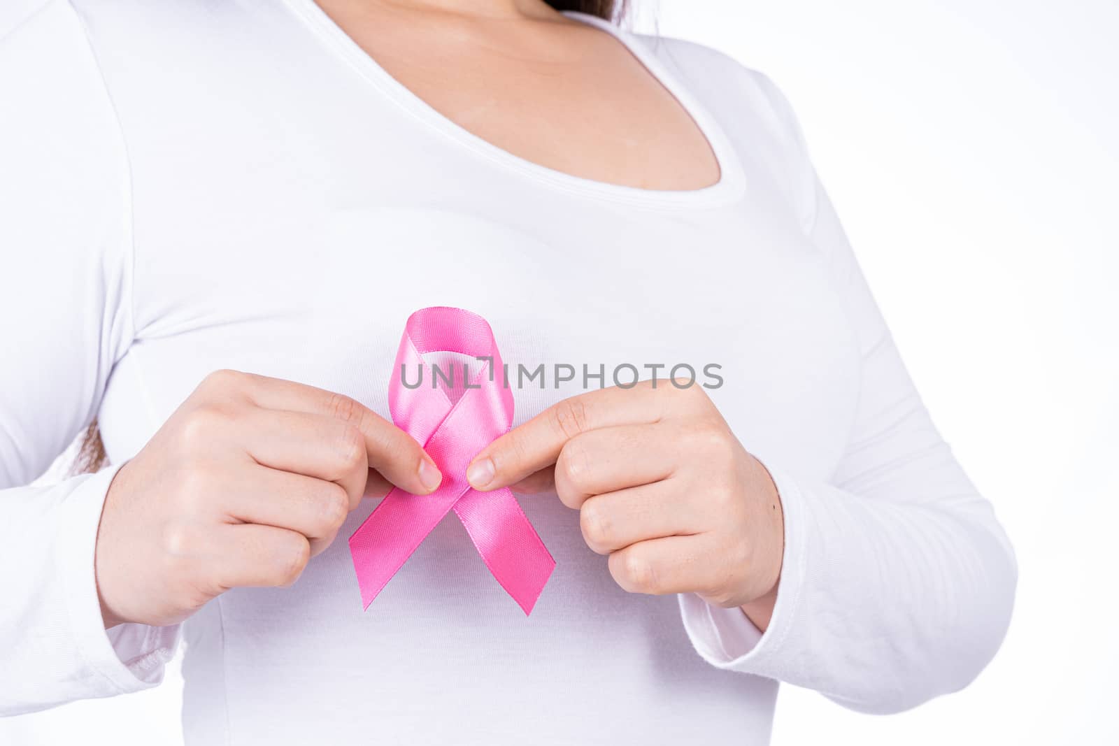 Breast cancer awareness ribbon on woman chest isolated over white background. Medical, healthcare for advertising concept.