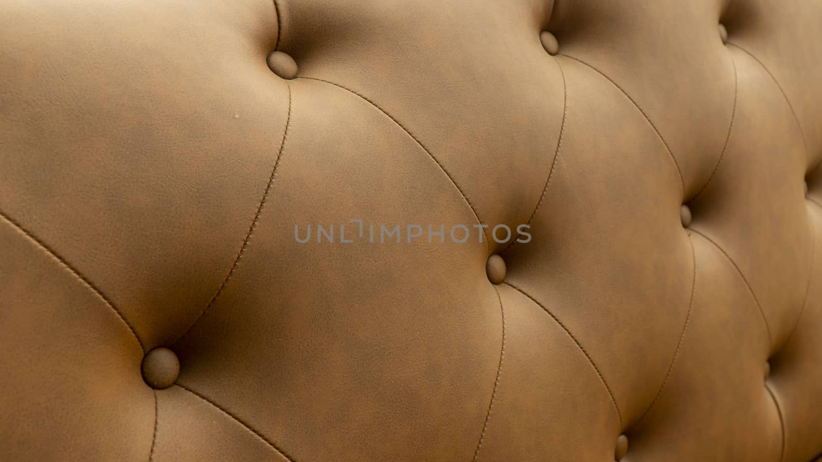 Close up of pins and buttons on a vintage style sofa. Buttoned vintage sofa up close.