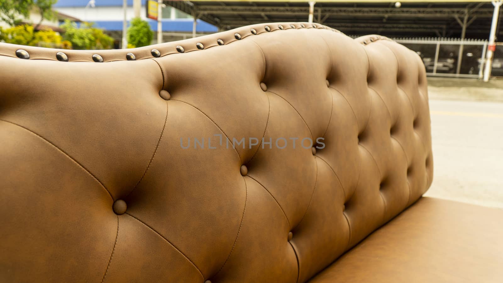 Close up of pins and buttons on a vintage style sofa. Buttoned vintage sofa up close.