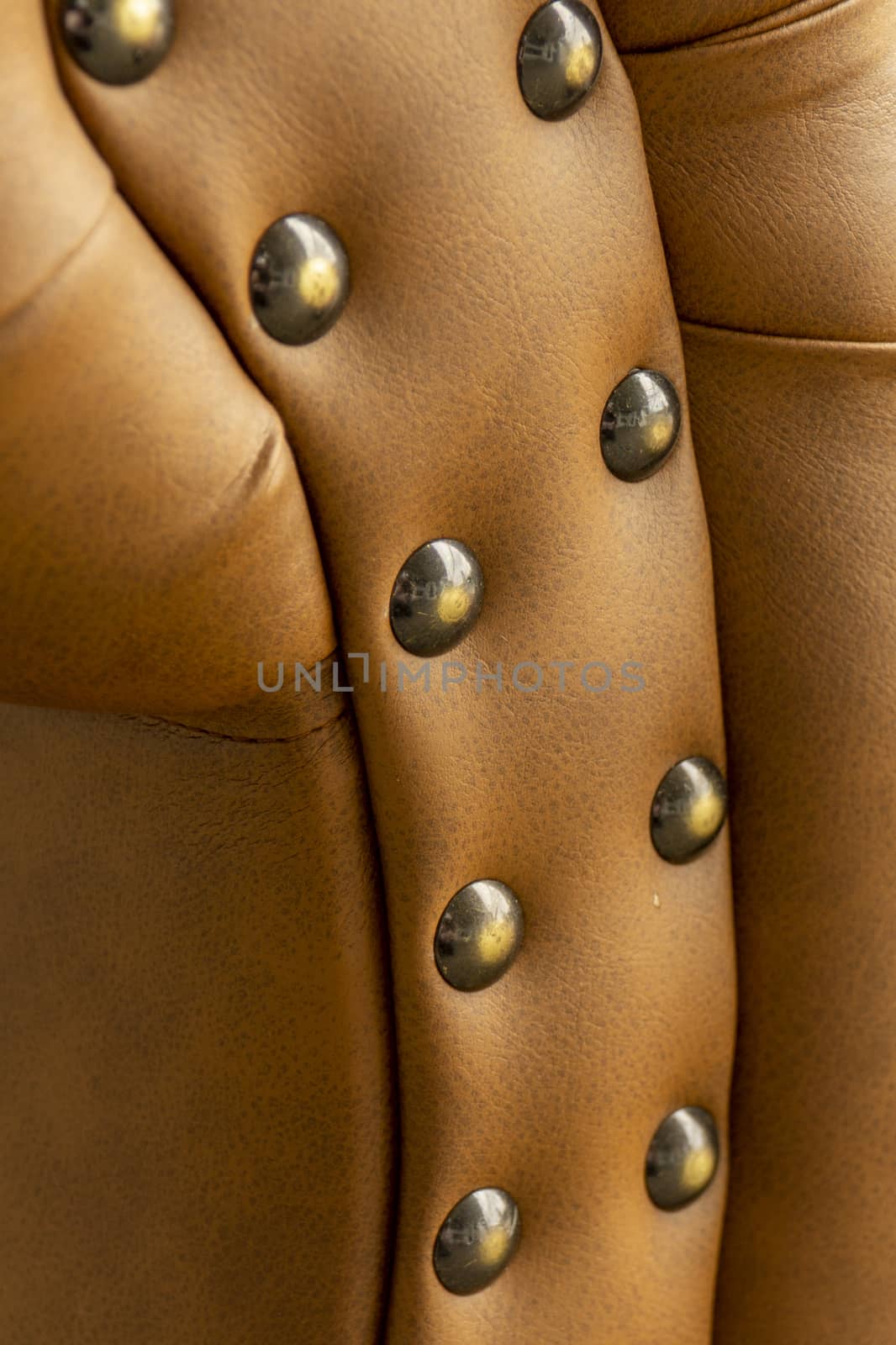 Close up of pins and buttons on a vintage style sofa. Buttoned vintage sofa up close.