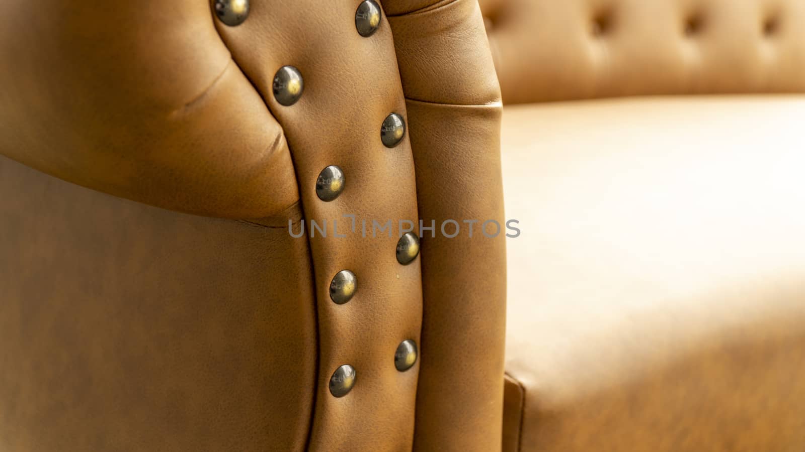 Close up of pins and buttons on a vintage style sofa. Buttoned vintage sofa up close.