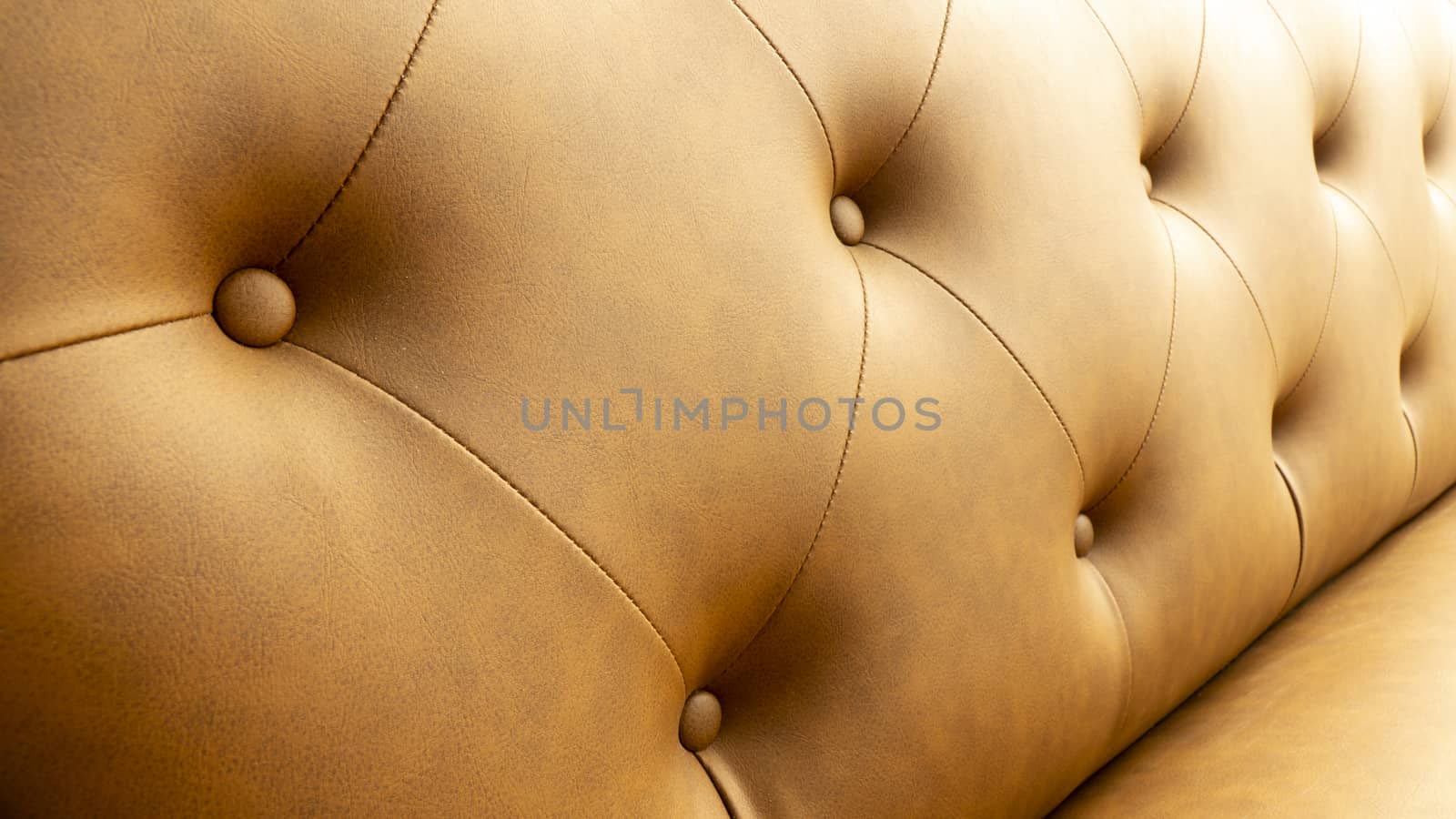 Close up of pins and buttons on a vintage style sofa. Buttoned vintage sofa up close.