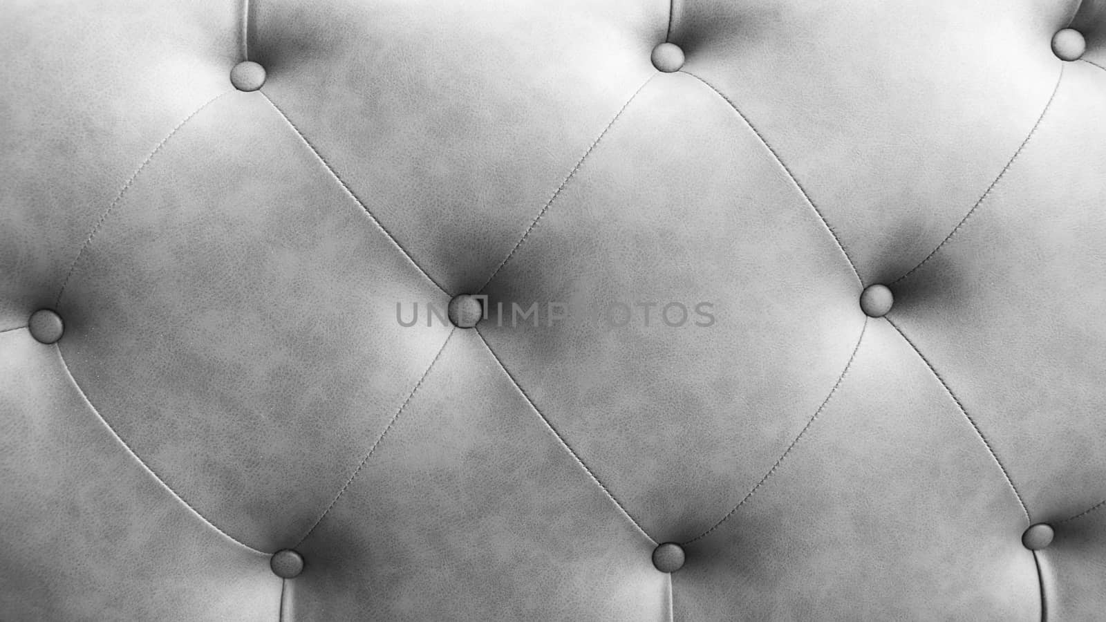Close up of pins and buttons on a vintage style sofa. Buttoned vintage sofa up close.