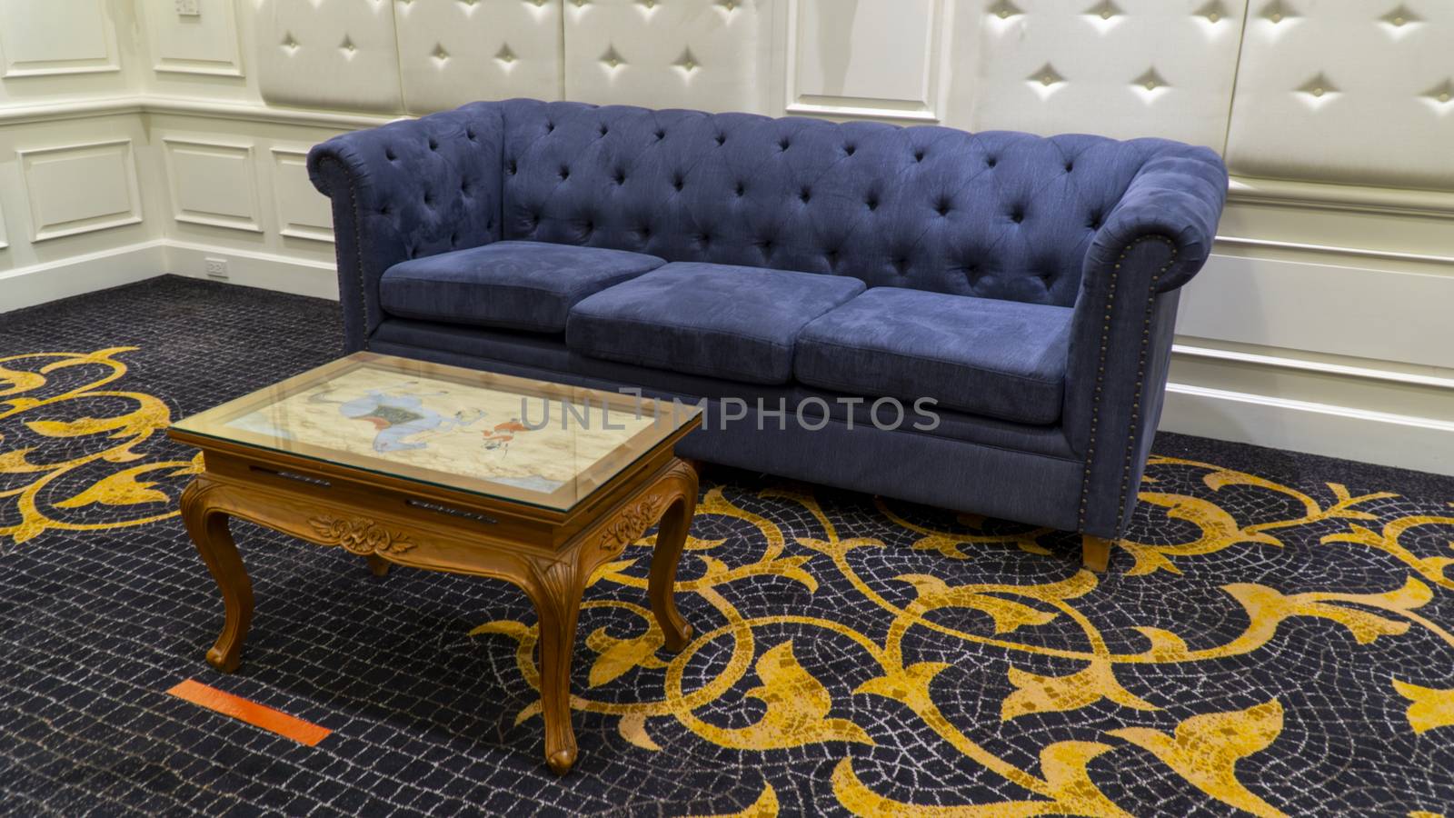 Blue vintage sofa with teak coffee table in a living room.