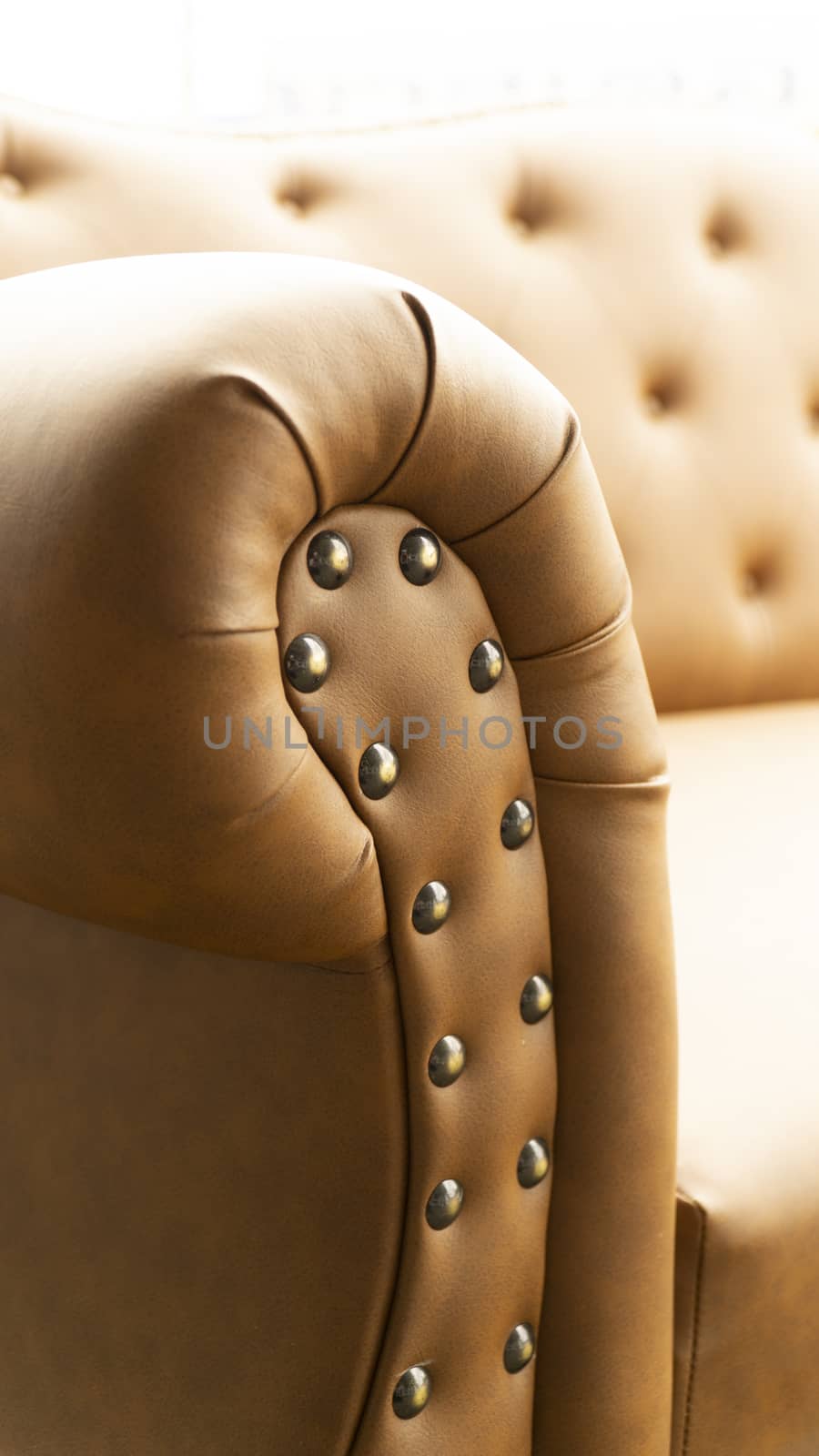 Close up of pins and buttons on a vintage style sofa. Buttoned vintage sofa up close.