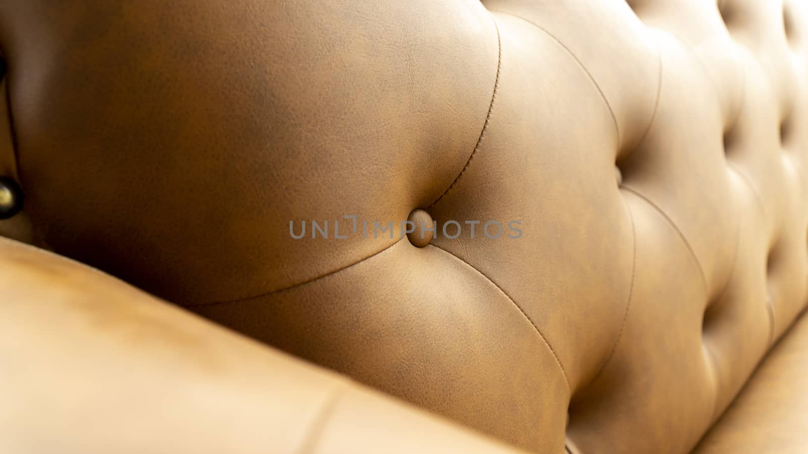 Close up of pins and buttons on a vintage style sofa. Buttoned vintage sofa up close.