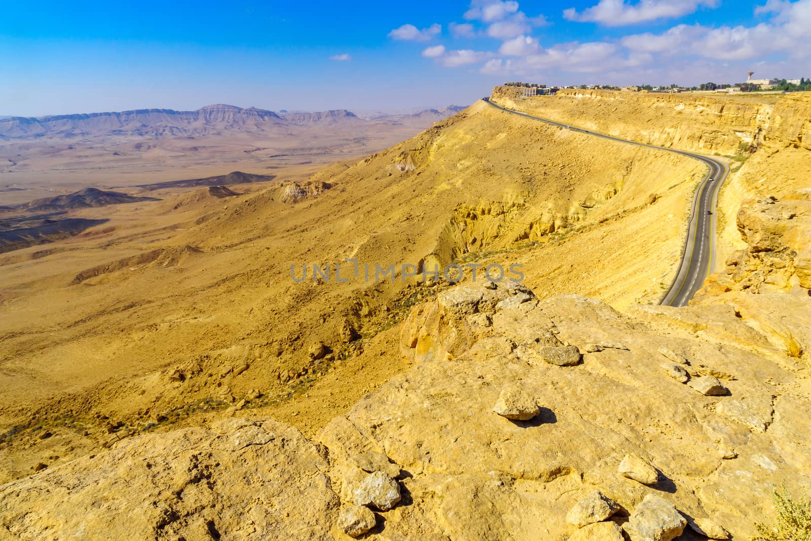 View of cliffs, landscape, and road in Makhtesh (crater) Ramon, the Negev Desert, Southern Israel