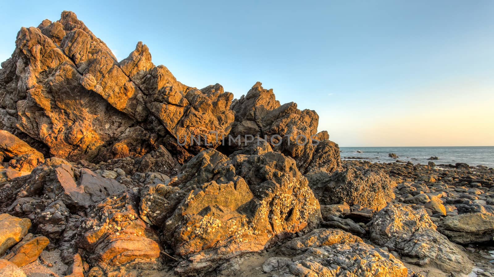 Dry rocks during low tide in afternoon sun light. Koh Lanta, Tha by Ivanko