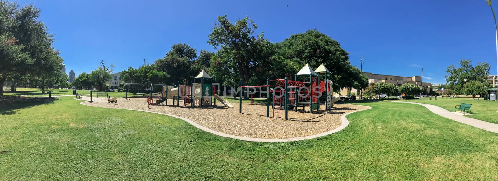 Panoramic urban playground surrounded by large trees and landmarks background in downtown Dallas, Texas, USA by trongnguyen