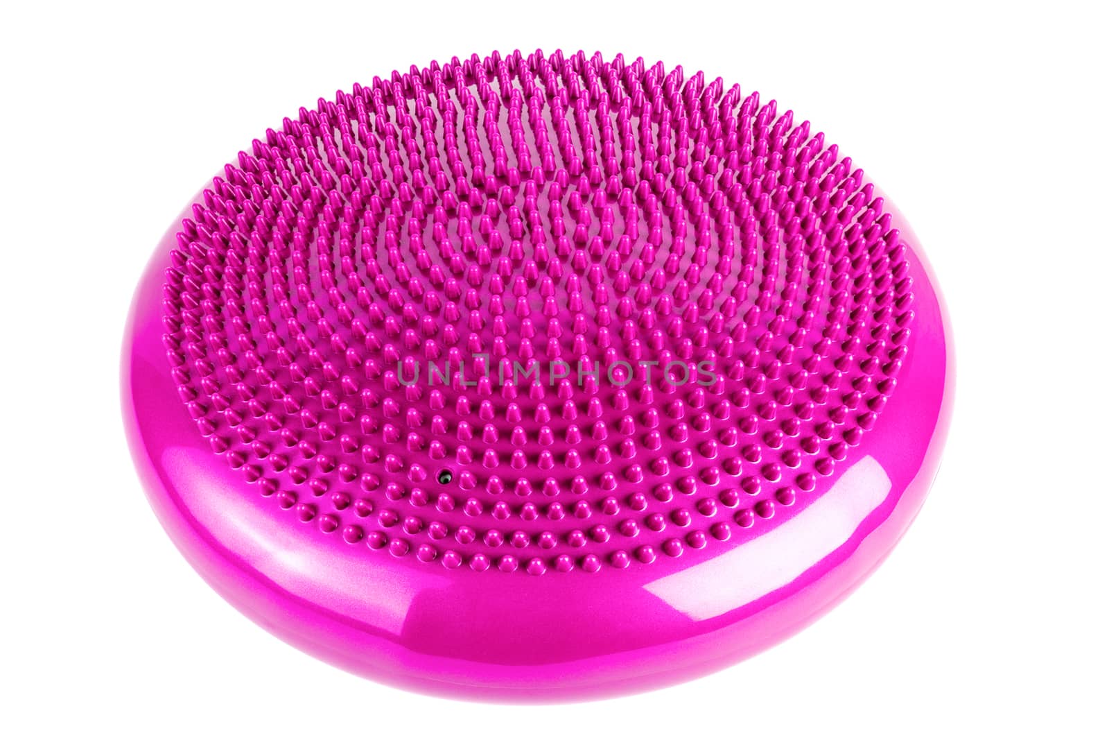 Pink inflatable balance disk isoleated on white background. A balance disk is a cushion can be used in fitness training as the base for core, balance, and stretching exercises. It is also known as a stability disc, wobble disc, and balance cushion.