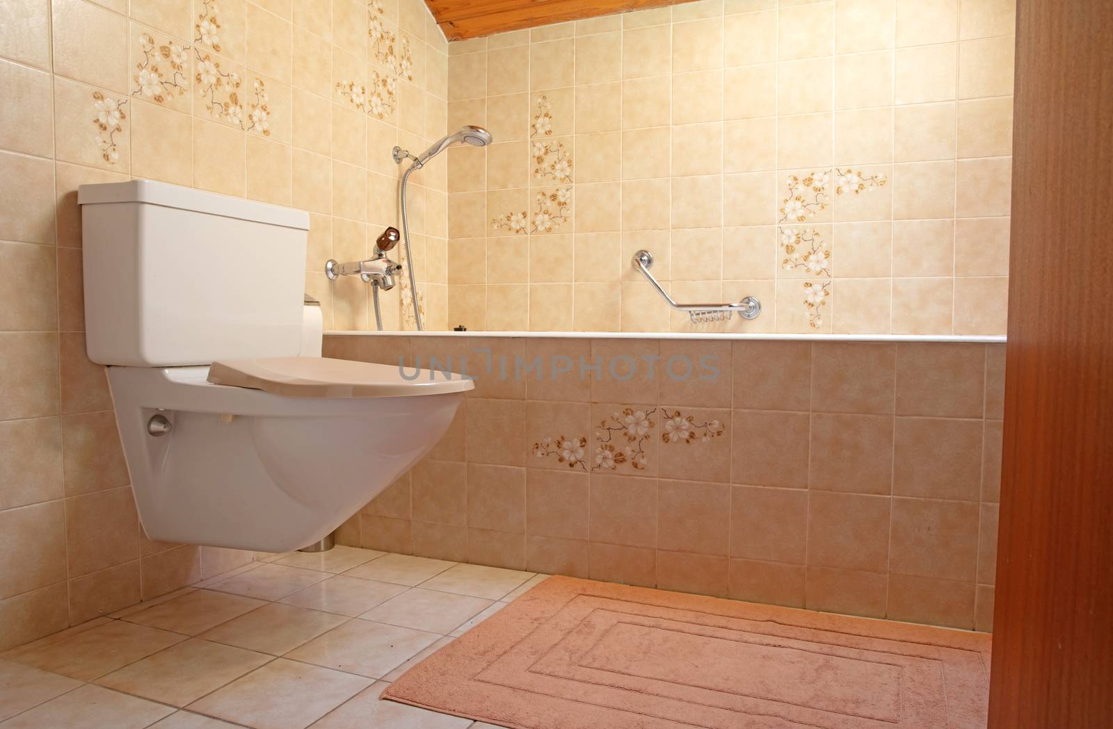 Very old toilet in a brown bathroom, empty