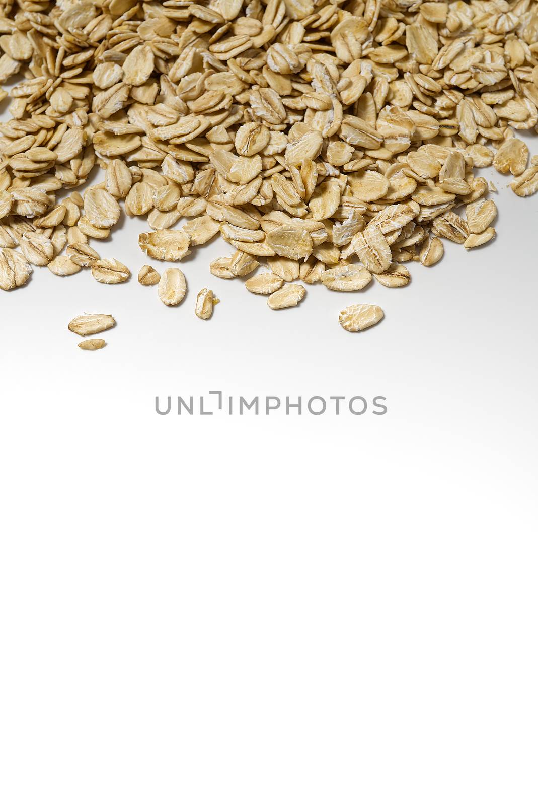 the organic healthy raw oat flakes on white background with copy space border. by PhotoTime