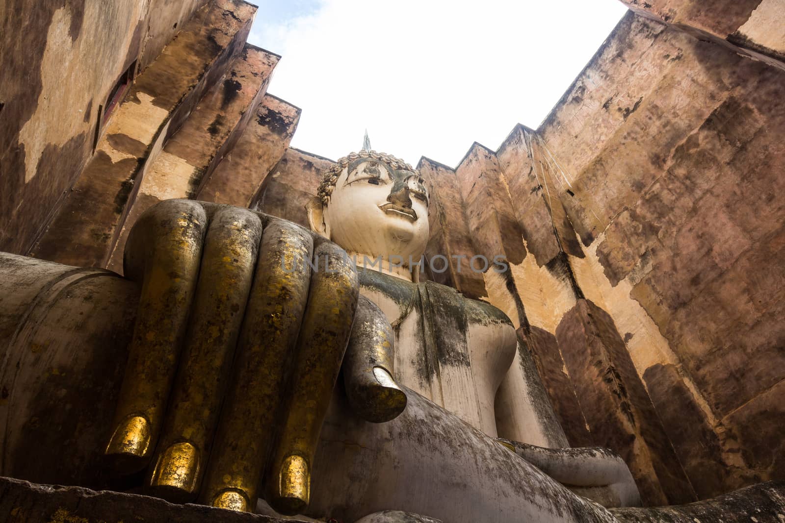 Sri Chum Temple is an ancient monument in the Sukhothai Historical Park. This temple is enshrined by the large Buddha, which is called "Phra Ajarna".  : Sukhothai,Thailand - JULY,01,2018