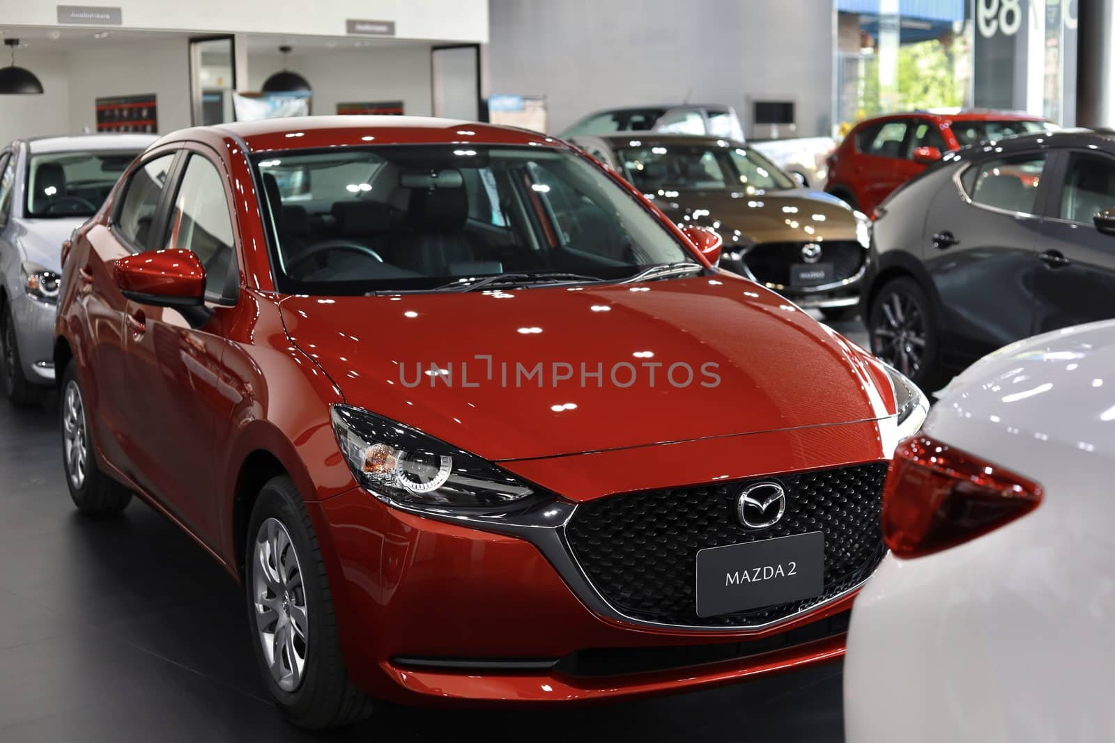 BANGSAEN,THAILAND 2020, car all new MAZDA3 MAZDA2 2020 brand japan red  color on room customer dealership in garage parked in showroom of thailand for transport Illustrative editorial image.