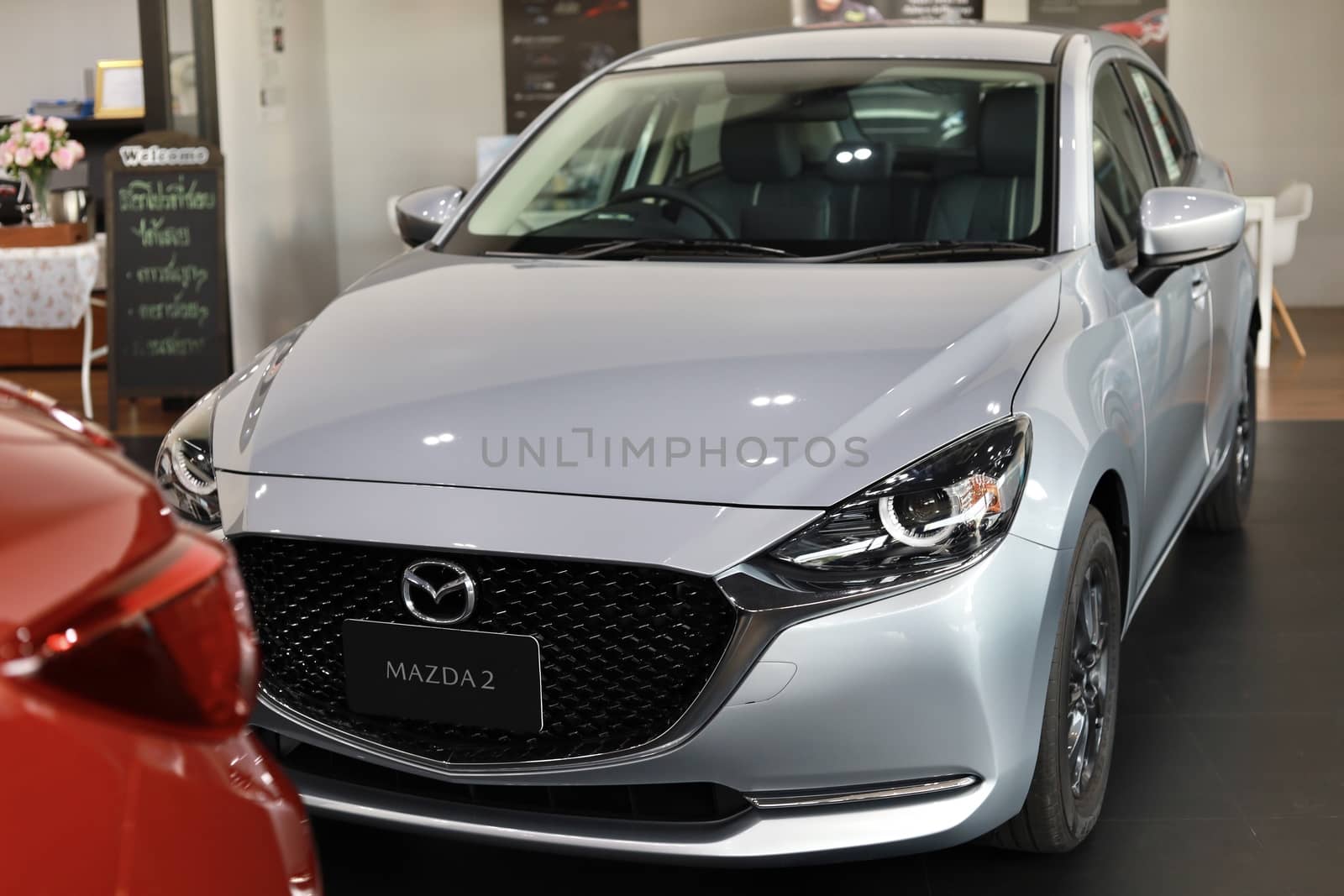 BANGSAEN,THAILAND 2020, car all new MAZDA3 MAZDA2 2020 brand japan red  color on room customer dealership in garage parked in showroom of thailand for transport Illustrative editorial image.