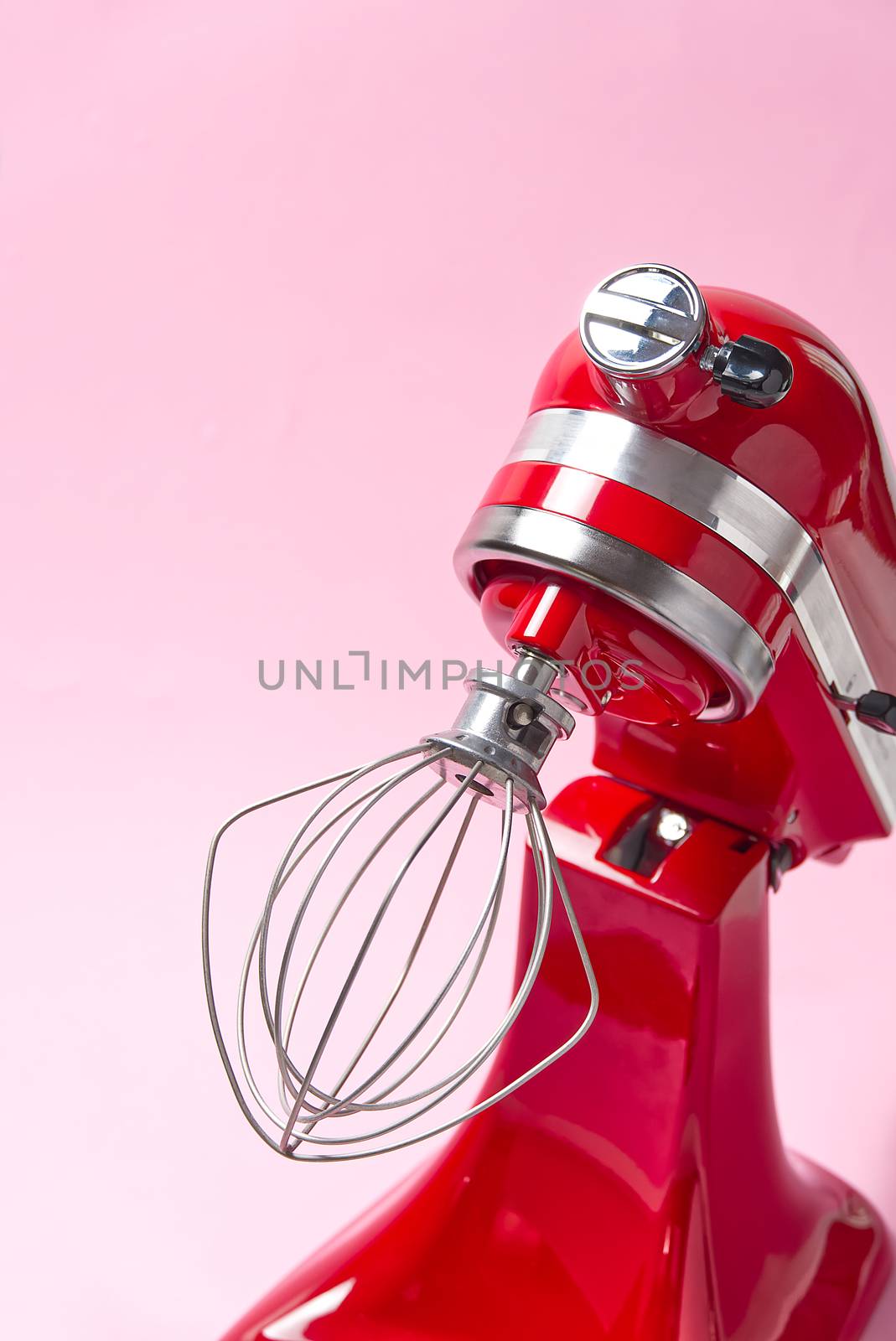 Red kitchen mixer on a pink background
