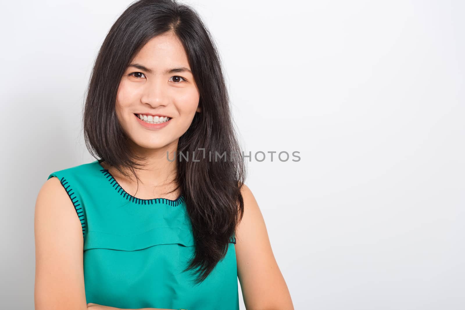 Portrait Asian beautiful young woman standing smile seeing white teeth, She looking at the camera, shoot photo in studio on white background. There was a copy space to put text on the right-hand side.