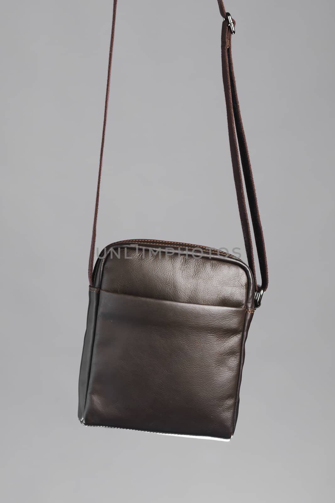 male brown leather bag, gray background by nikkytok