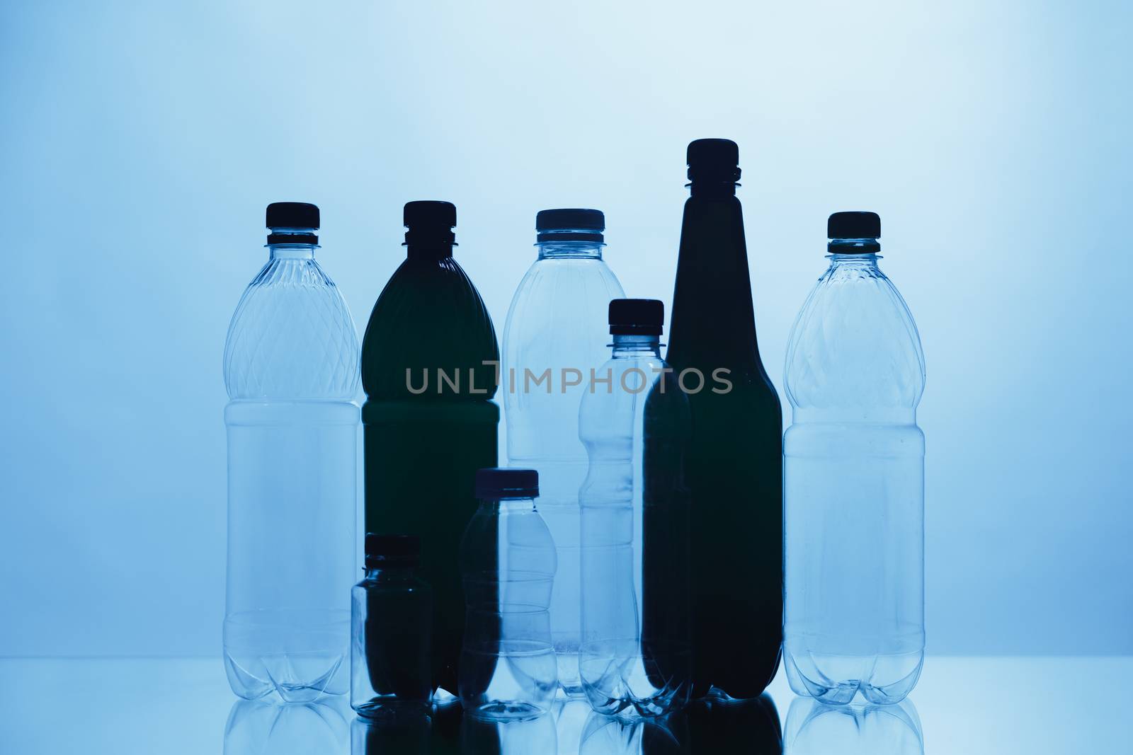 empty plastic bottle silhouettes on blue background by nikkytok