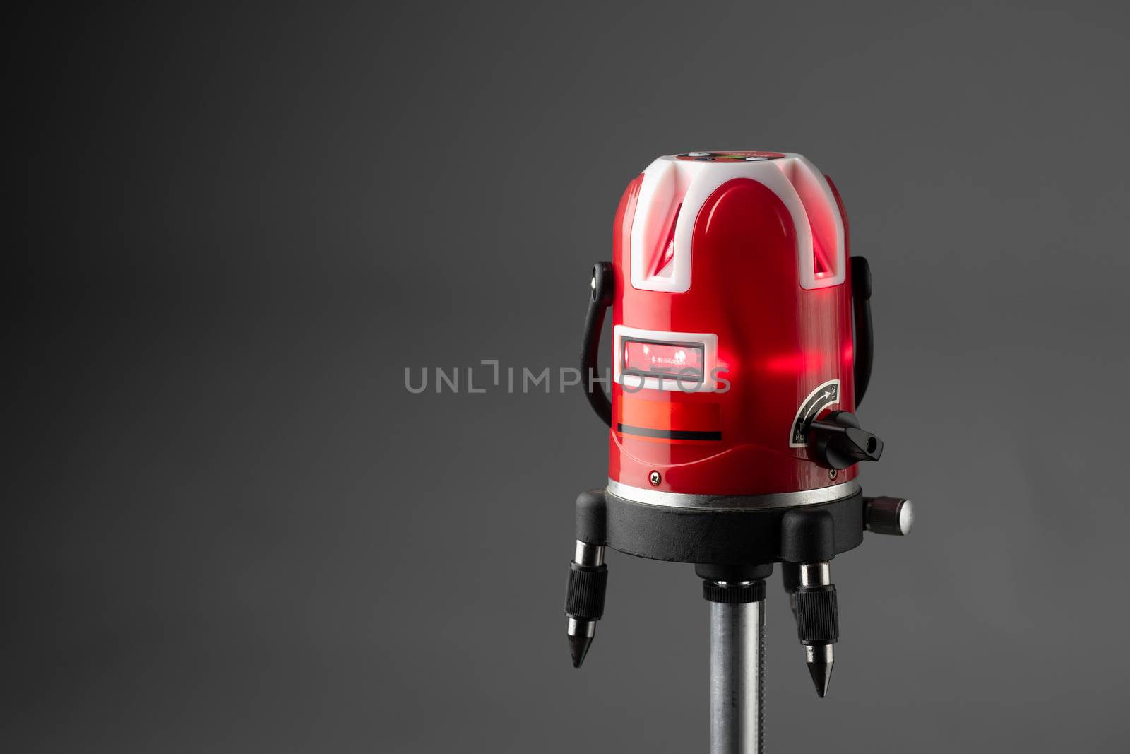 red laser level tool on grey background