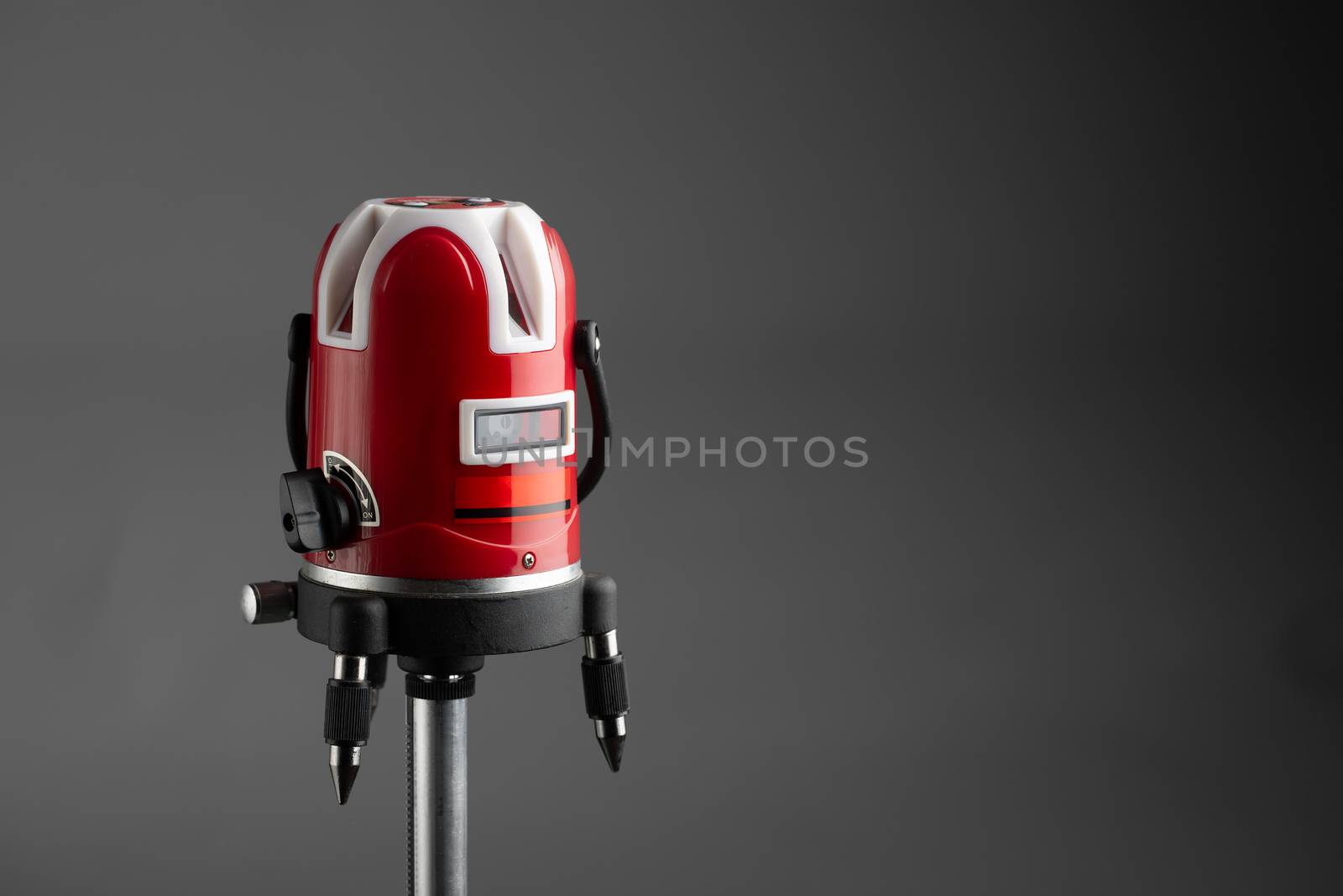 red laser level tool on grey background