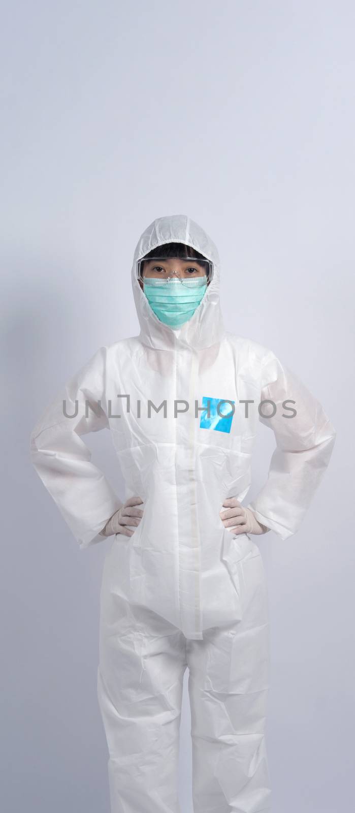 Woman doctor in PPE or personal protection equipment suit  by gnepphoto