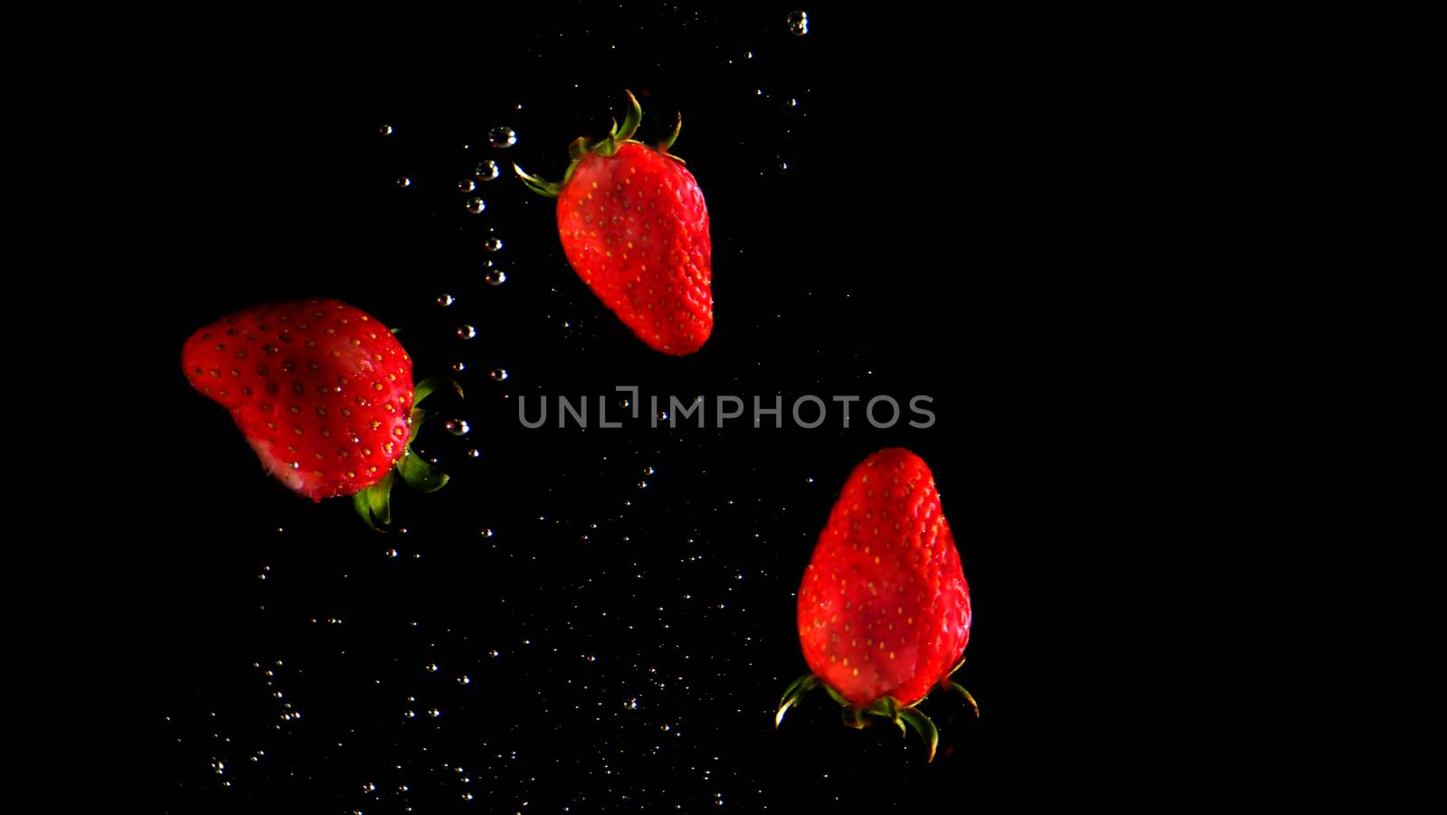 Colorful fresh vegetable cleaning by drop in to water splash and black background.