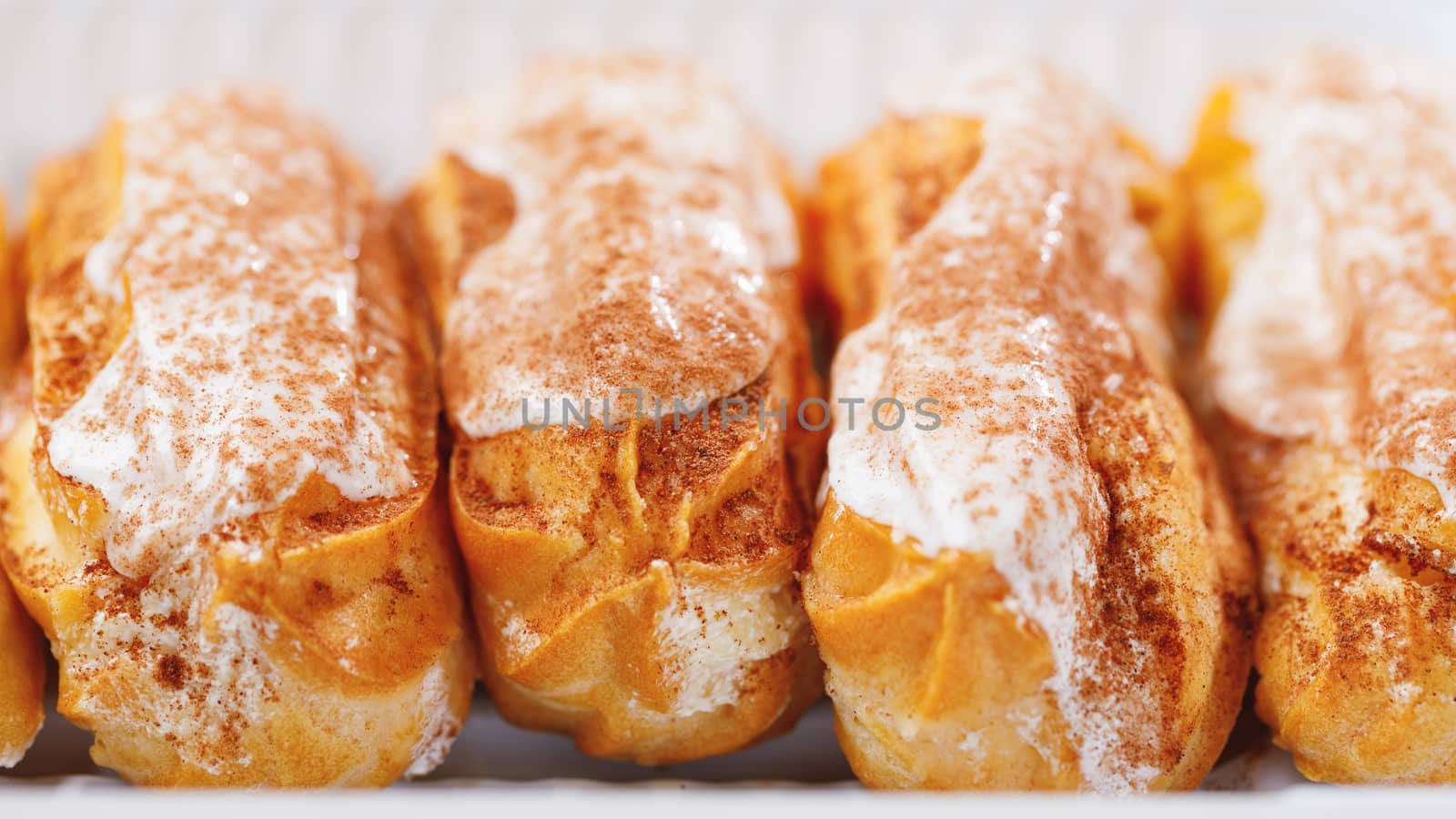 eclairs pastry in a plastic box, close-up view