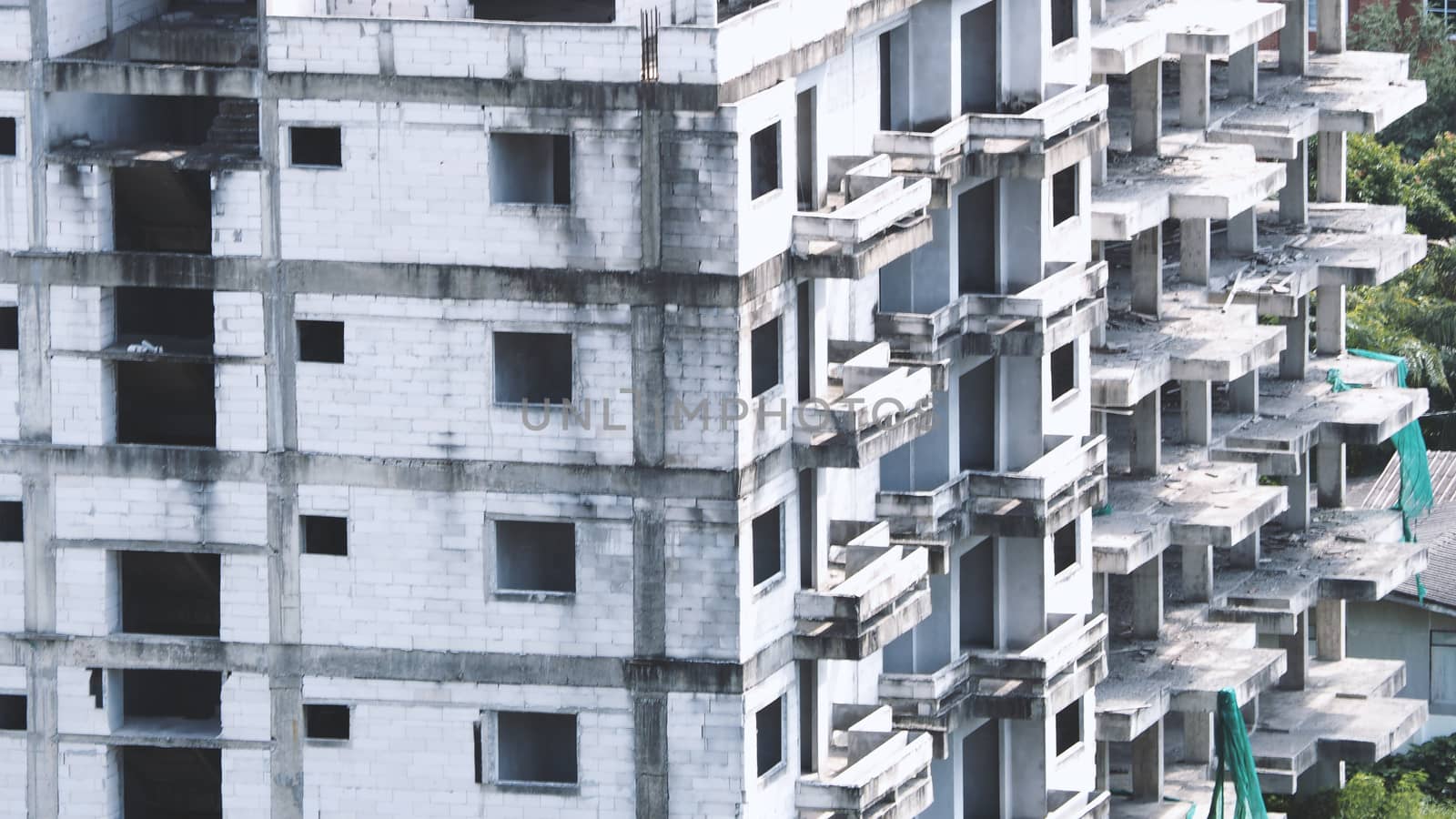 Blurred images of abandoned old dirty building or tower which unfinished construction because of no budget.