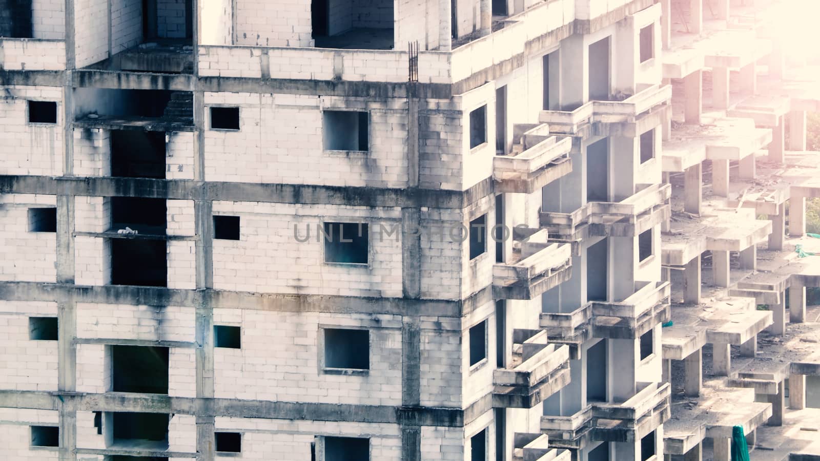 Blurred images of abandoned old dirty building or tower which unfinished construction because of no budget.