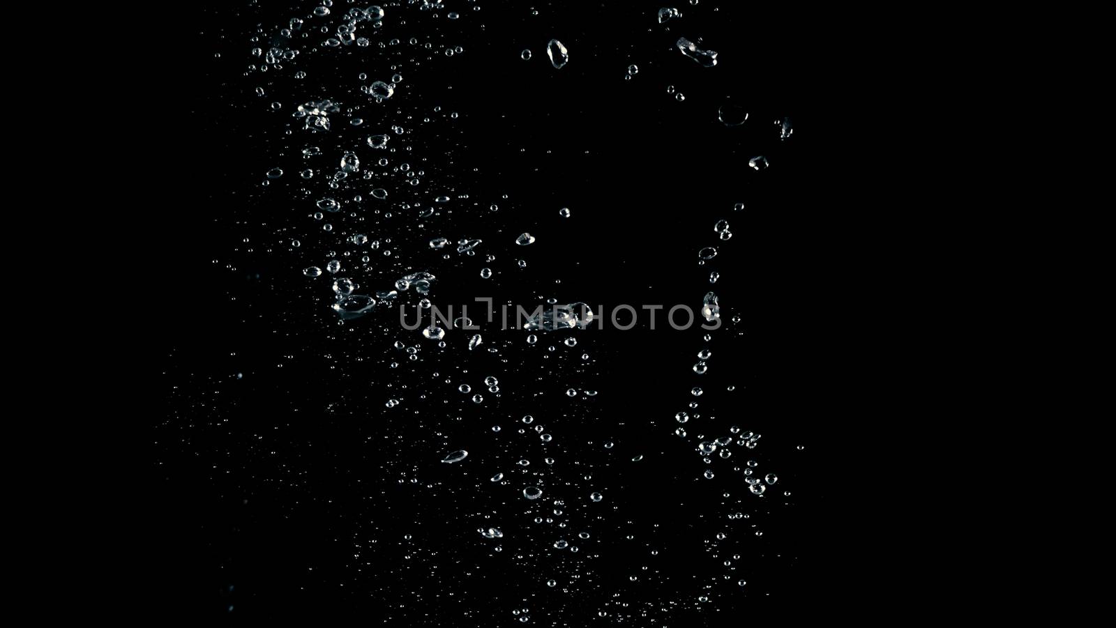 Soda water liquid splashing bubbles drop in black background represent sparkling and refreshing