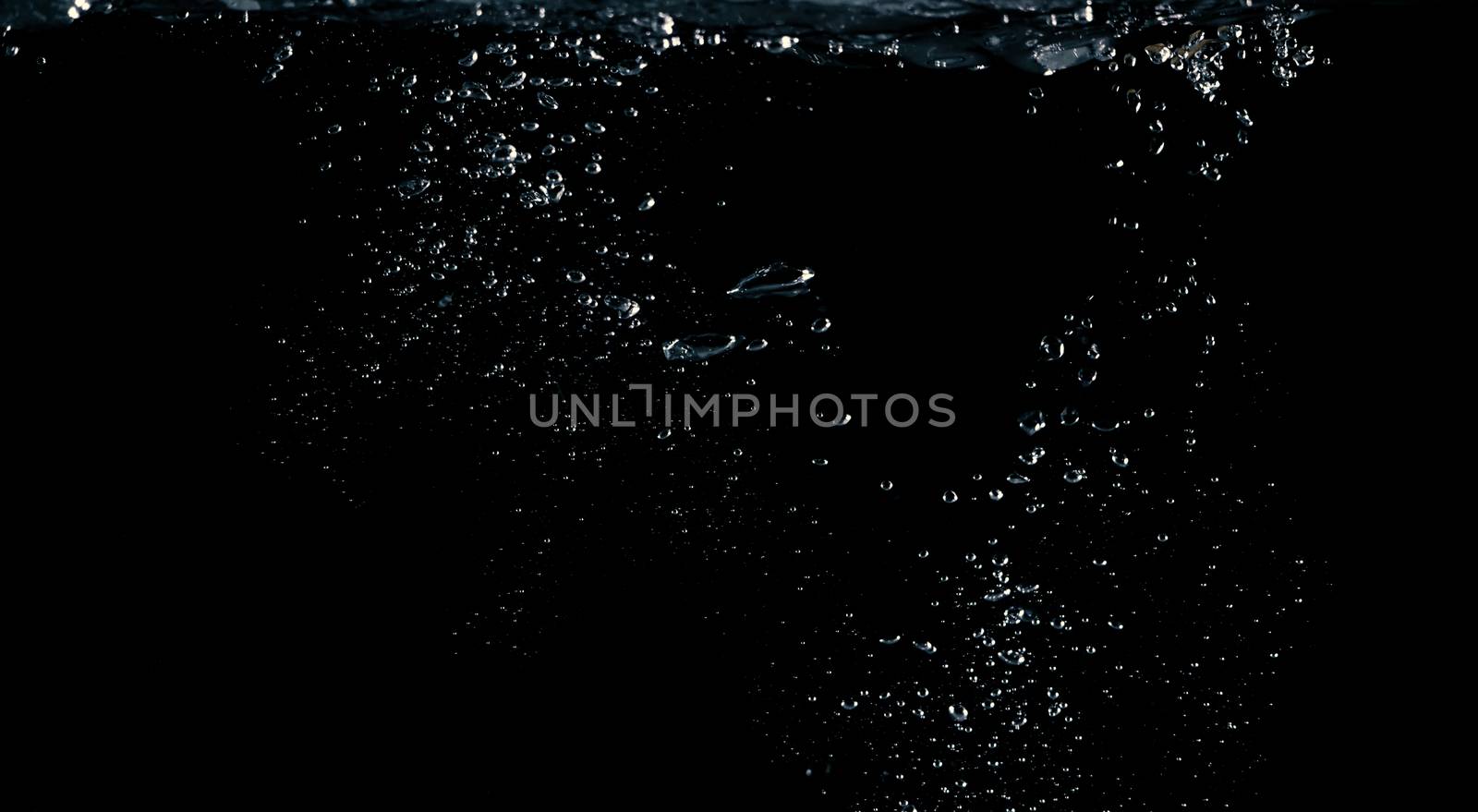 Soda water liquid splashing bubbles drop in black background represent sparkling and refreshing