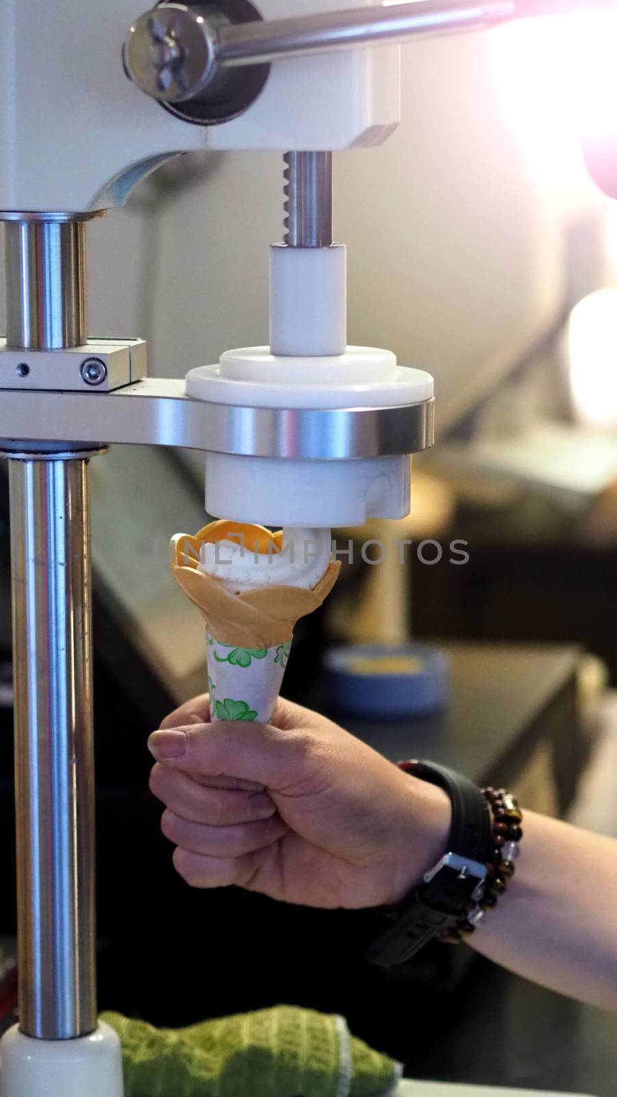 Soft serve ice cream cone made by machine by gnepphoto