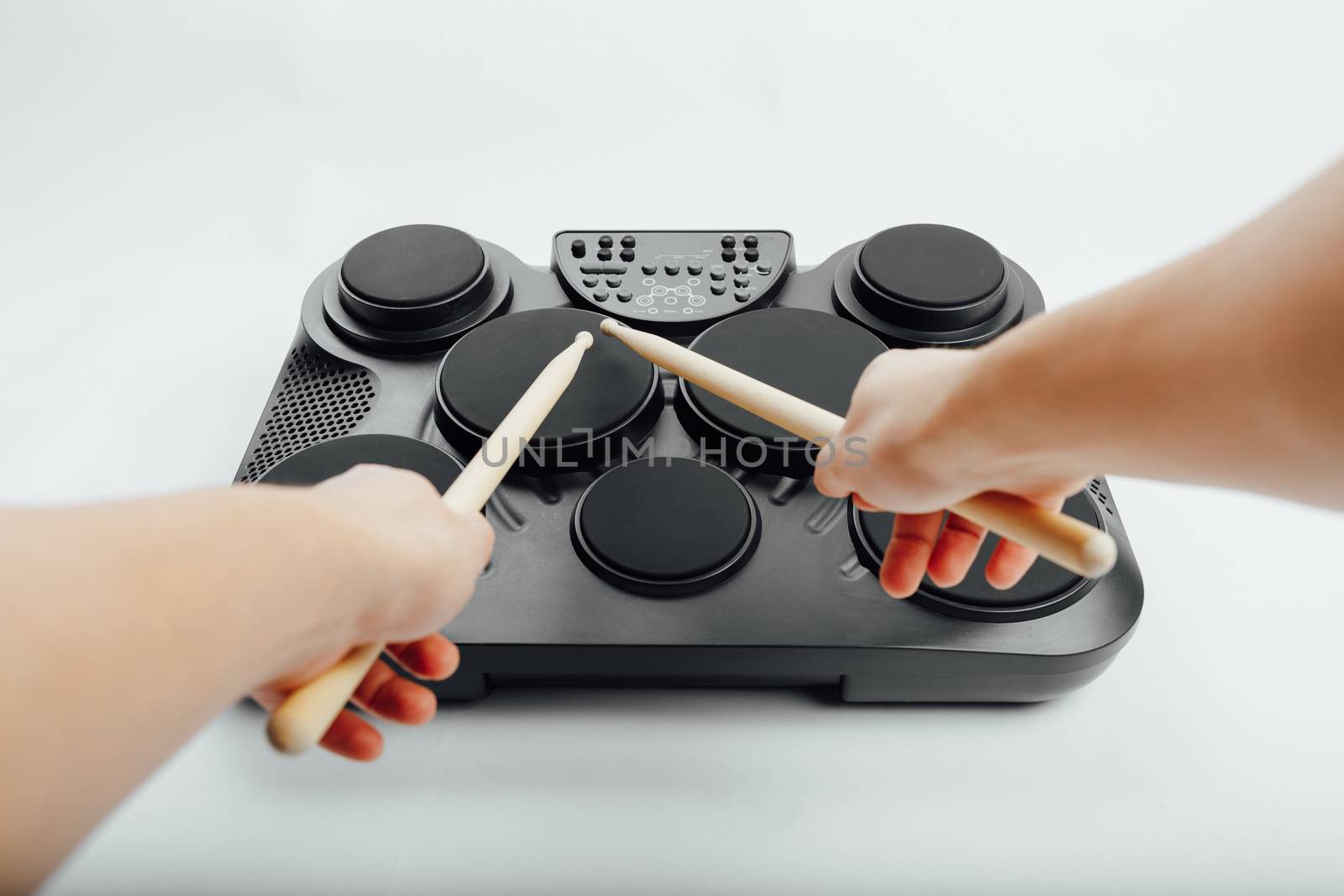 hands playing on portable electronic drums, white background by nikkytok