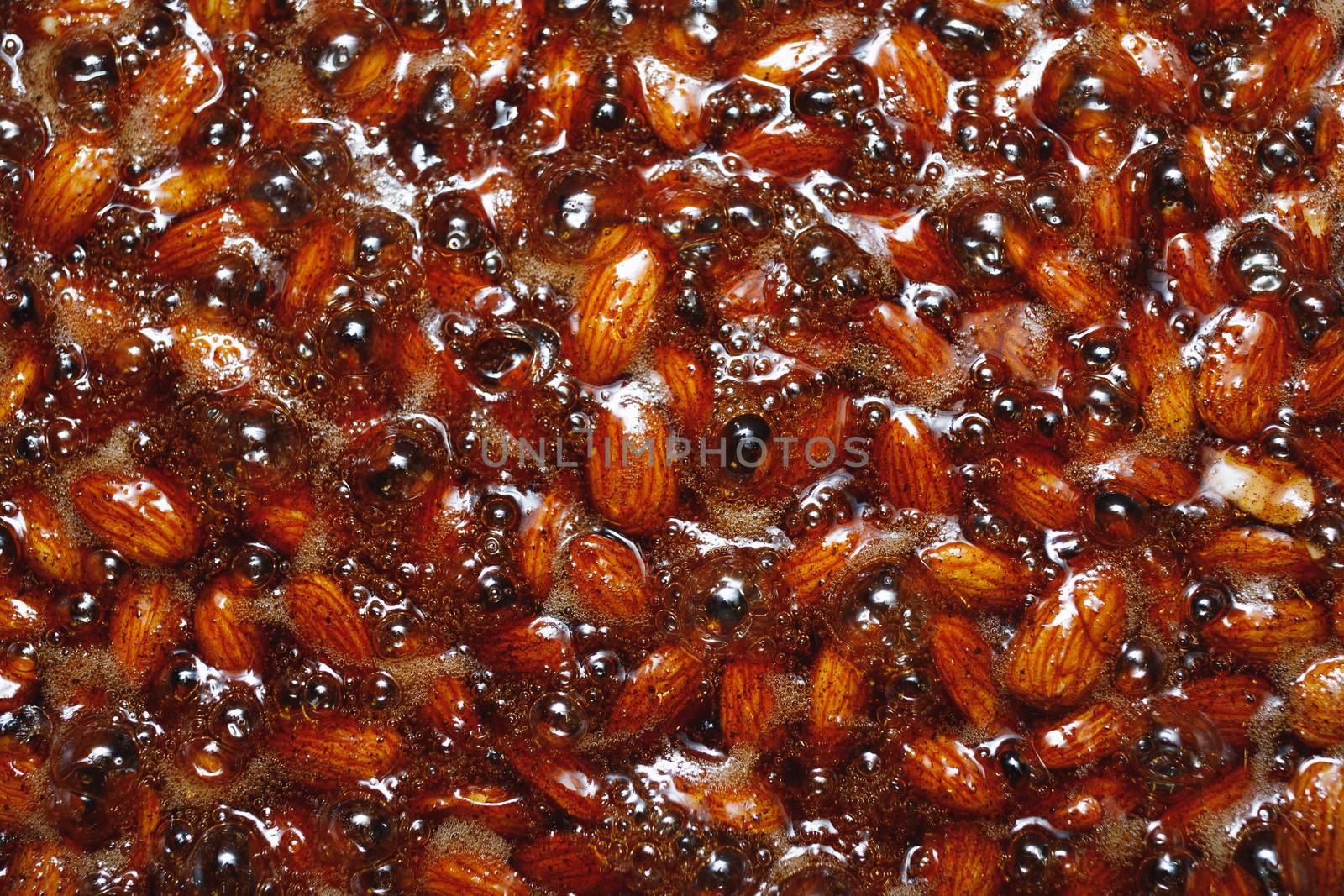 roasted almonds with cinnamon sugar cooking process, top view close-up