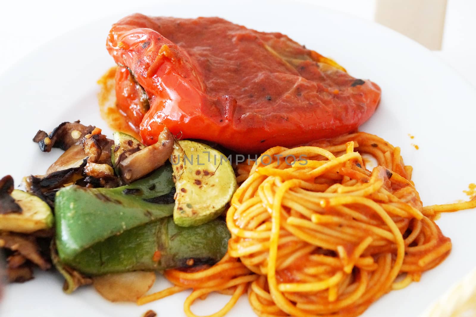Italian pasta with baked vegetables close up by Annado