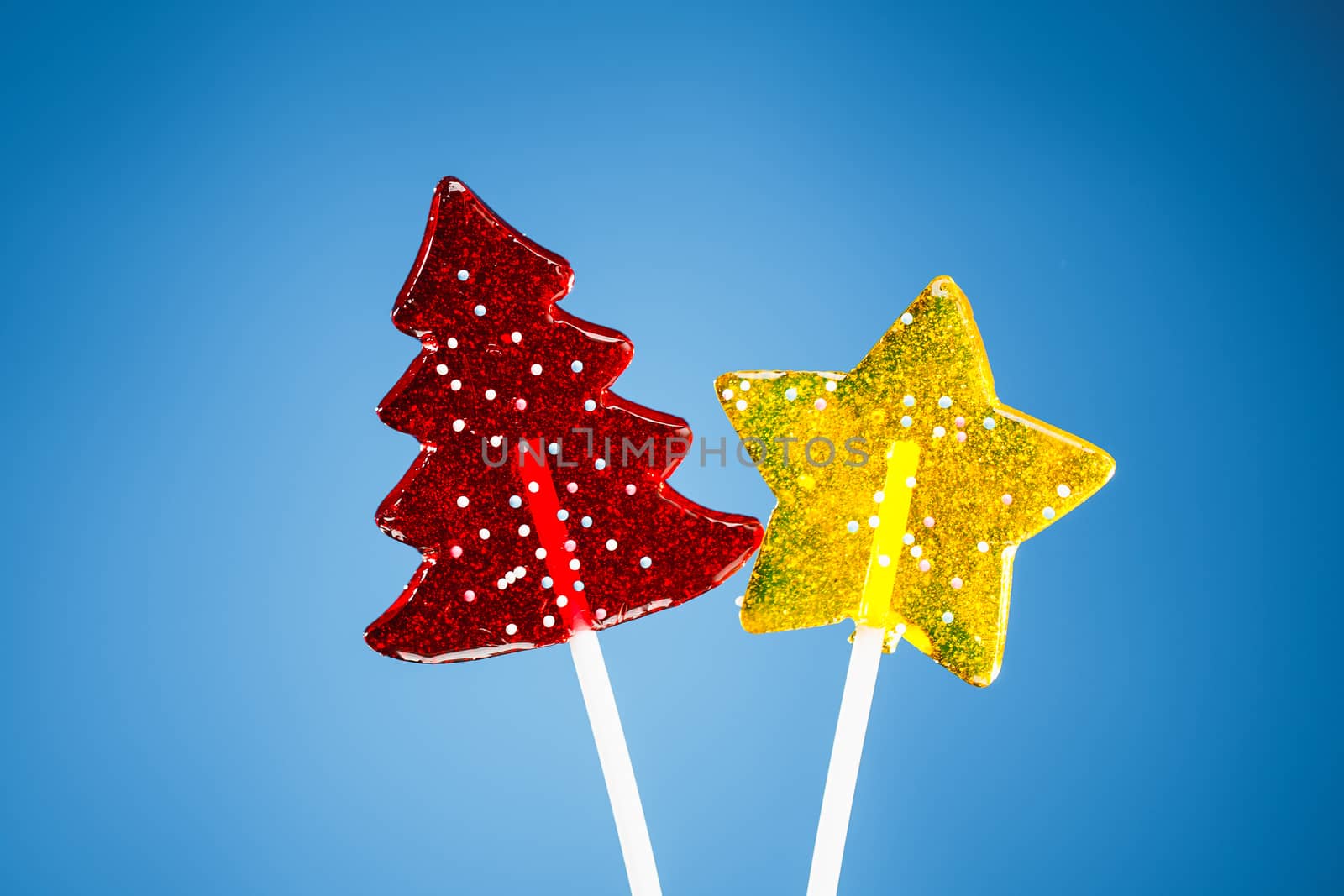 red Christmas tree and yellow star candy, blue background