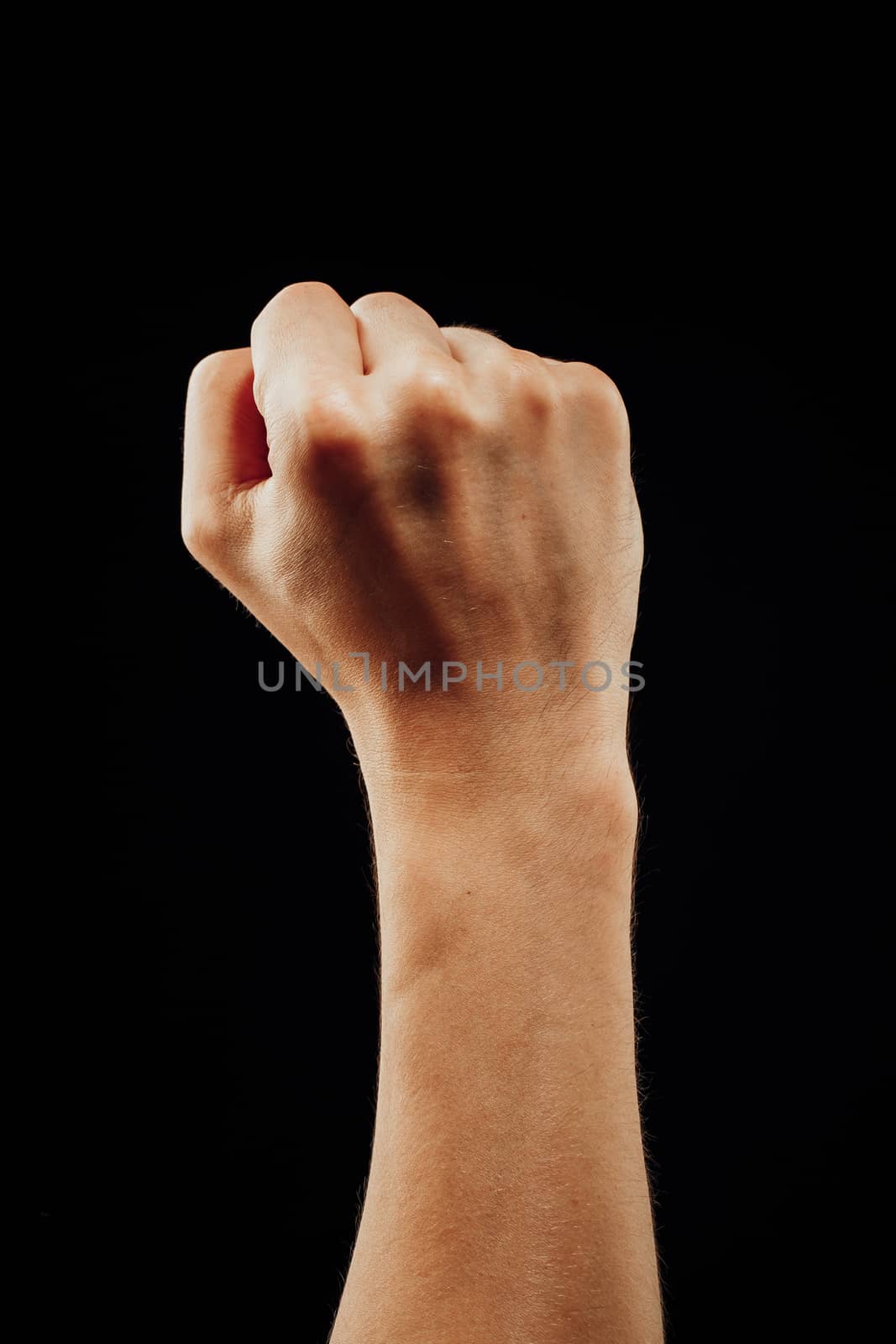 male fist, isolated on black