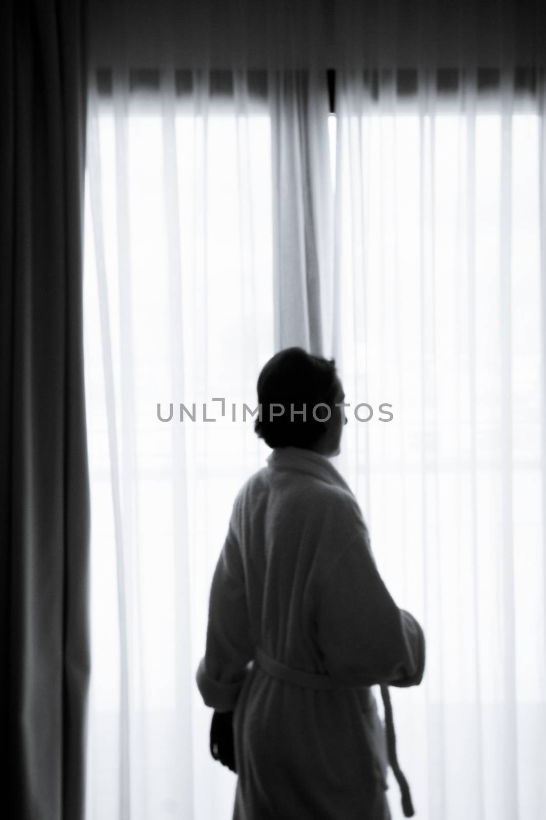 Silhouette of woman with bathrobe in front of a window by GemaIbarra