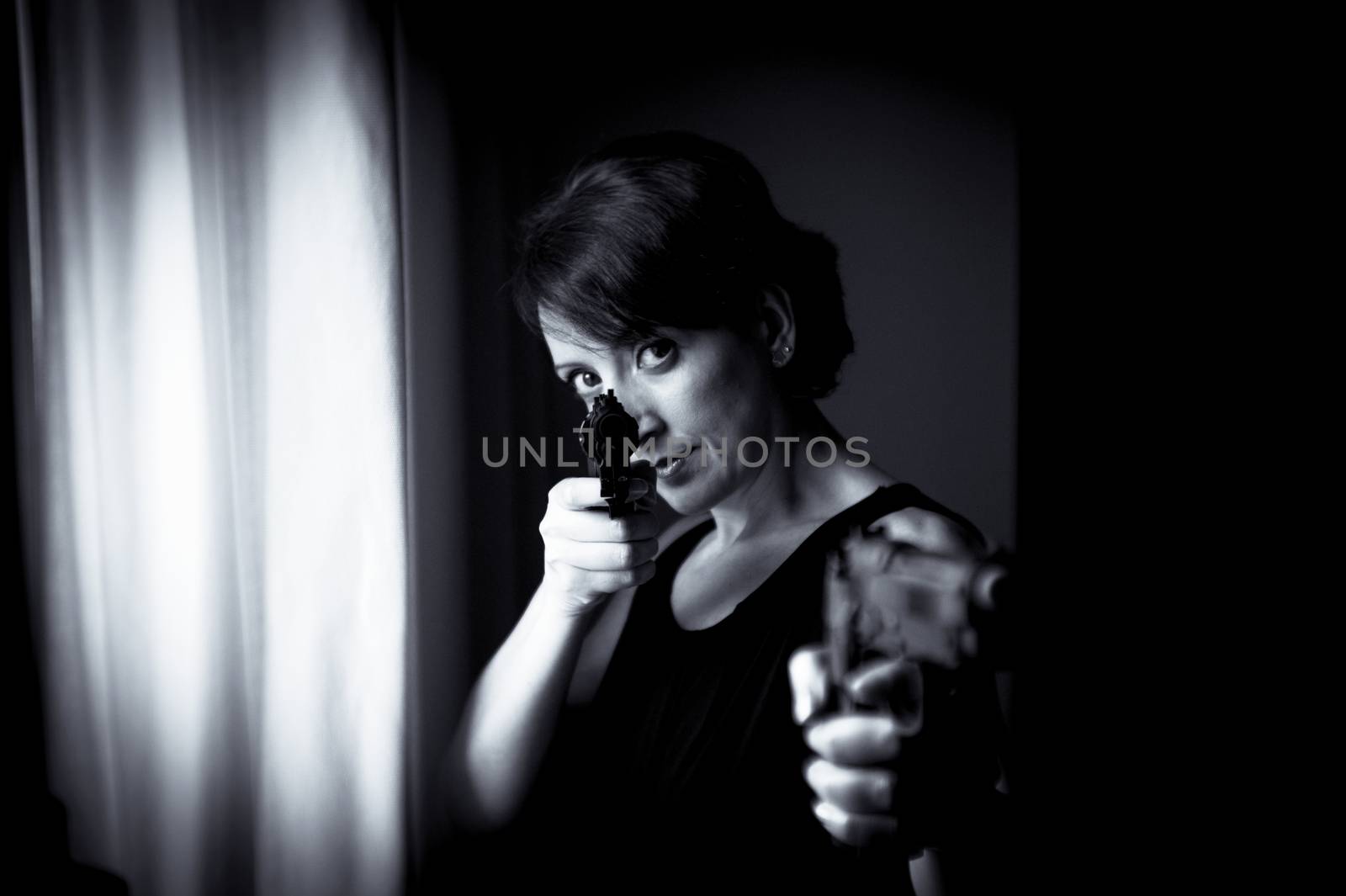 Portrait of woman with gun. Black dress